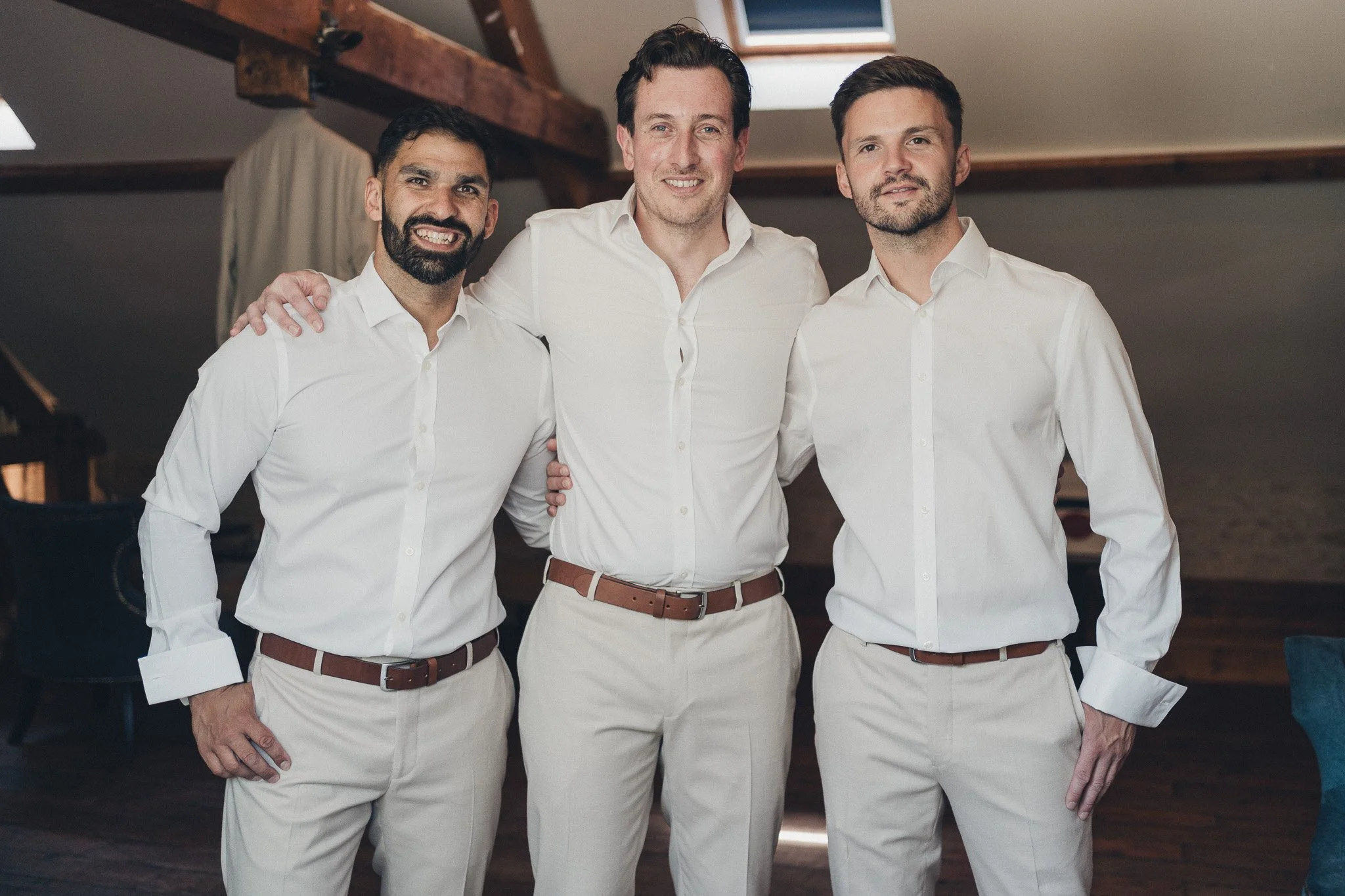 Groom and groomsmen posing together before the wedding ceremony.
