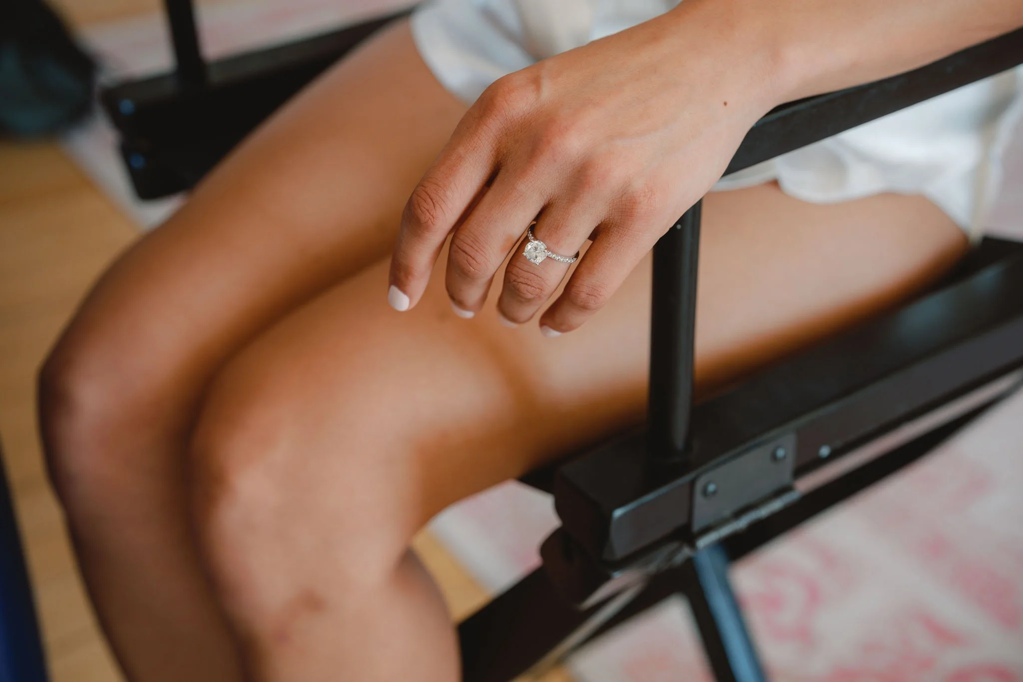 Detail photograph of the bride's hand resting on a chair arm at Paradis des Vignes, Charente
