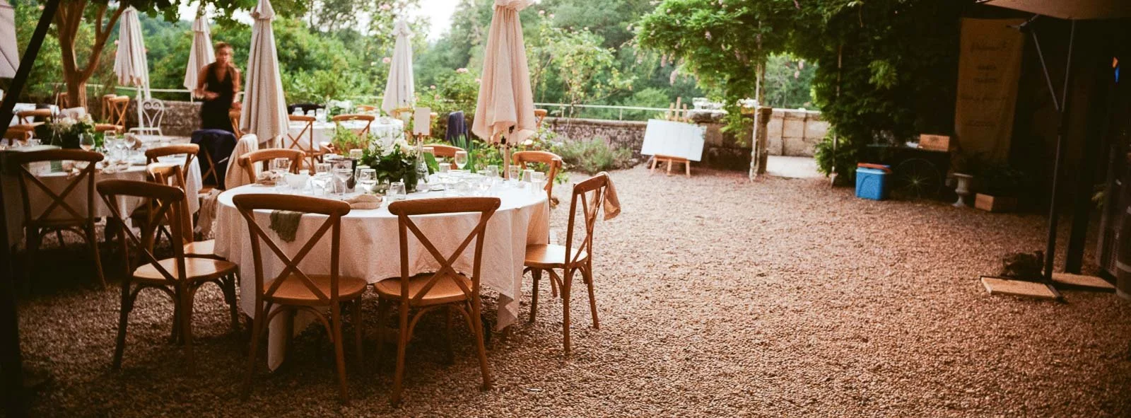 Panoramic Hasselblad XPan film photograph of the reception tables set under the trees at Château Lagorce