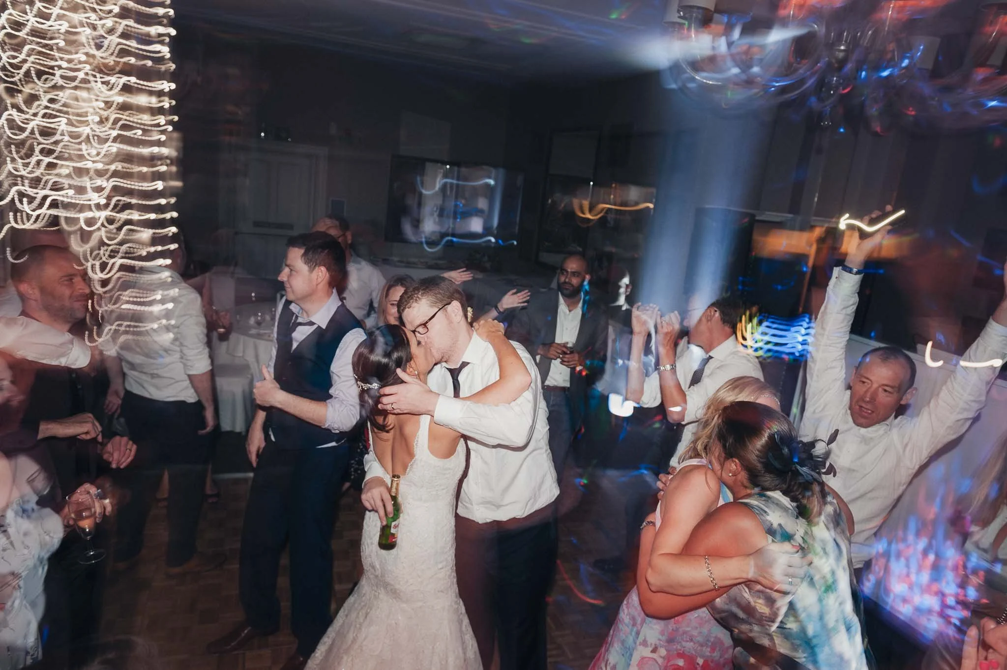 The bride and groom dancing closely during the lively evening party.