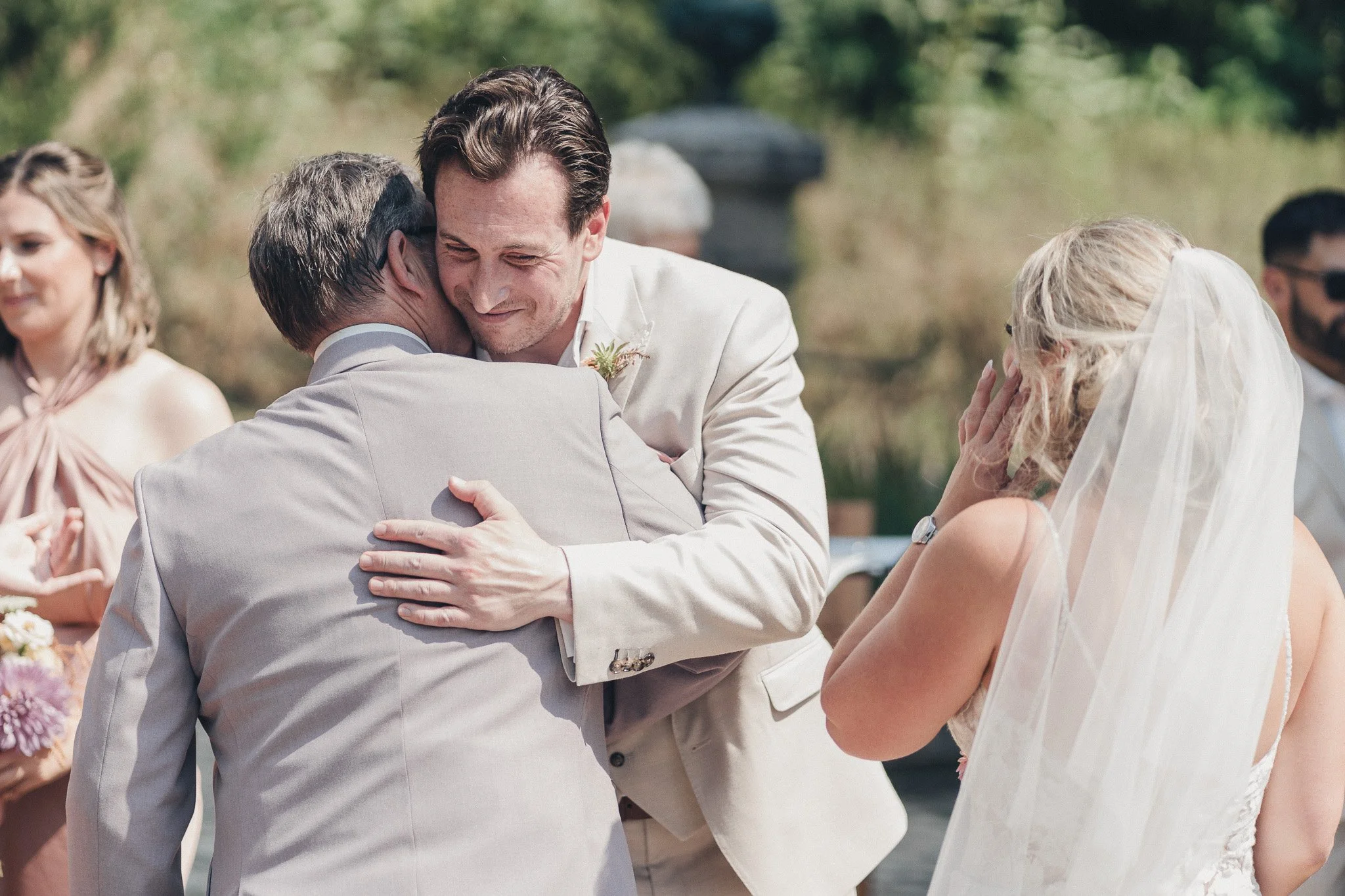 Groom embracing the father of the bride during the wedding ceremony