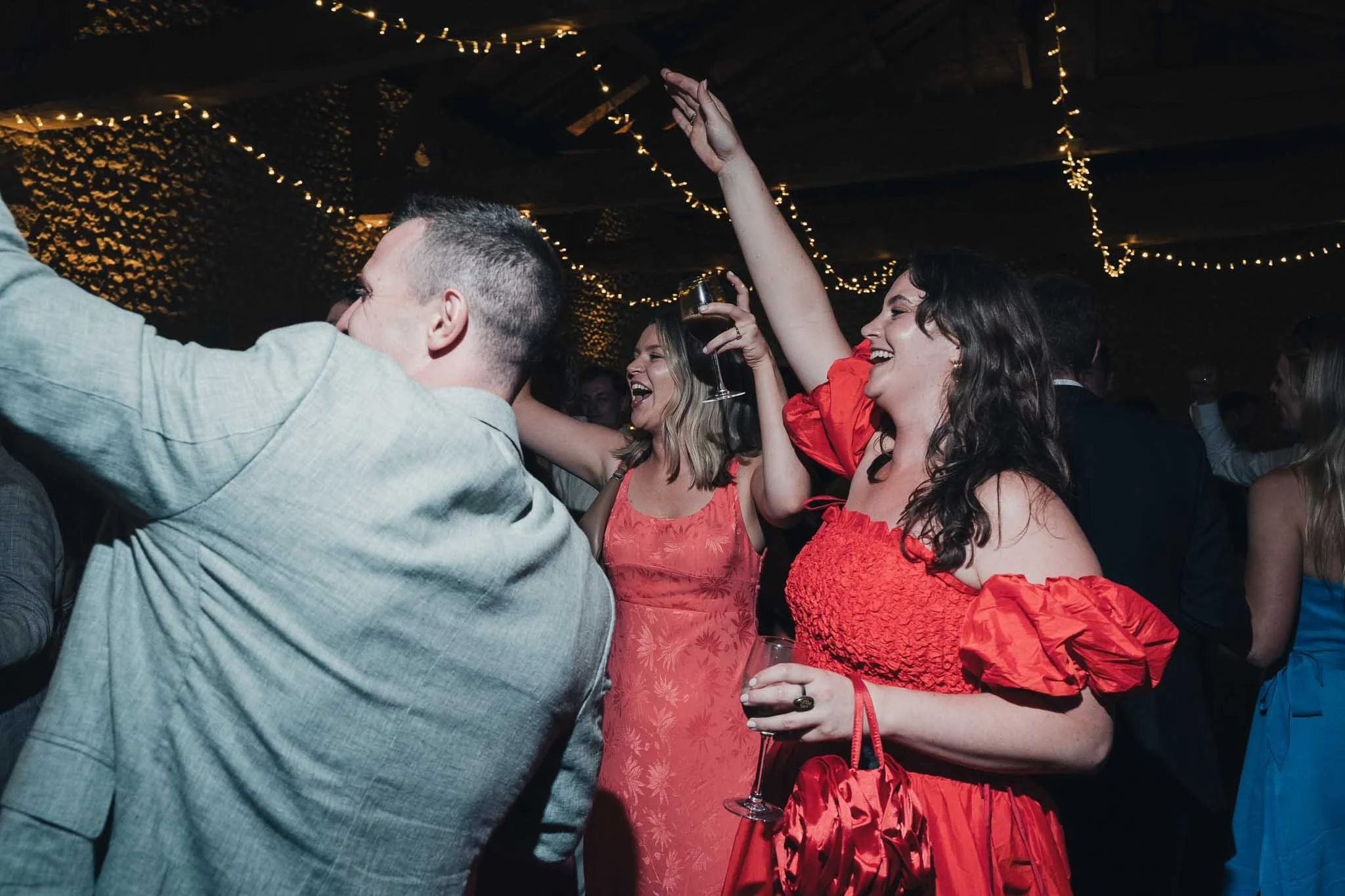Guests dancing, laughing and raising their hands during the evening celebrations.