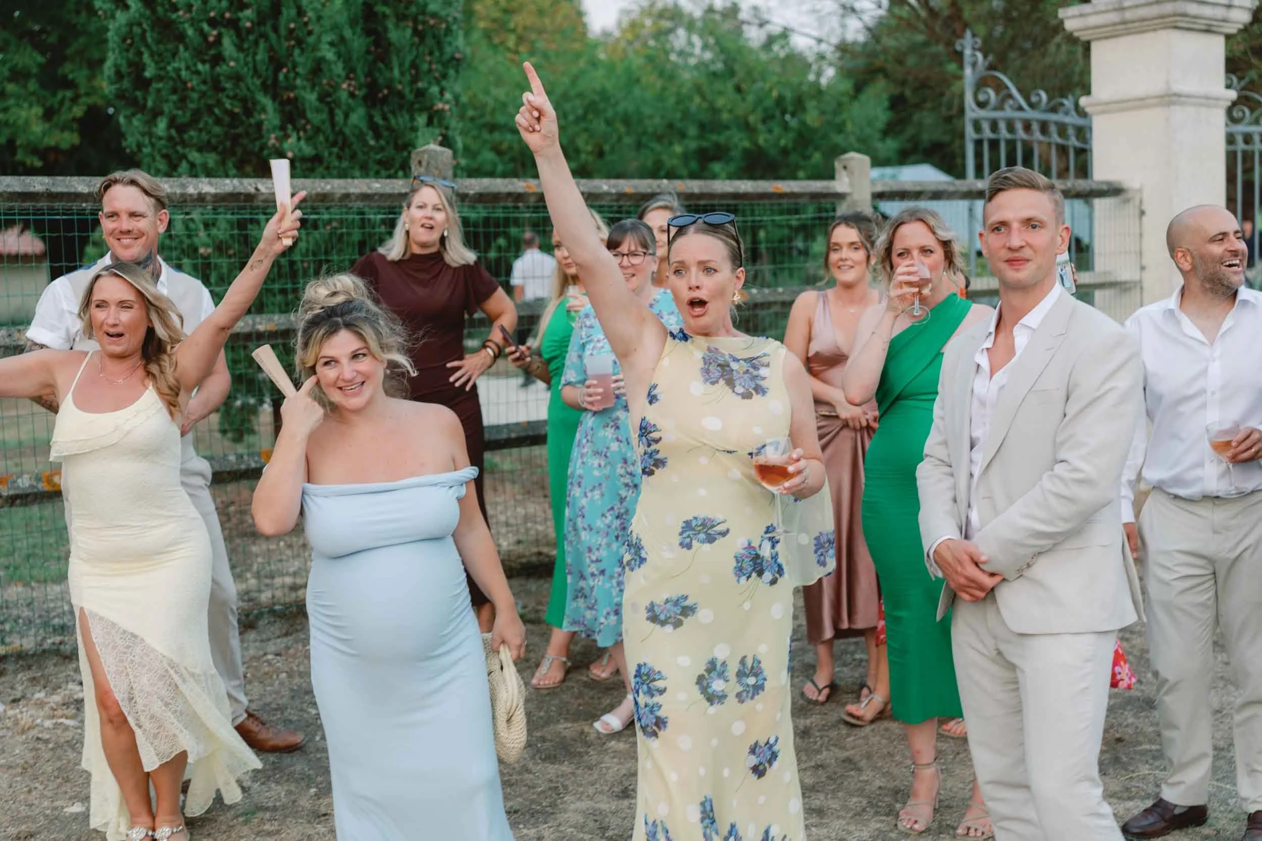 Wedding guests laughing and cheering at Paradis des Vignes, Charente