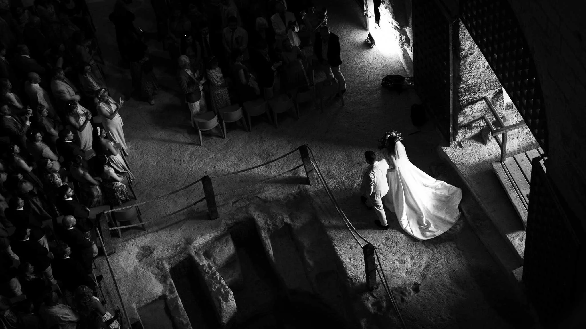 Dramatic aerial black and white photograph of wedding ceremony in France