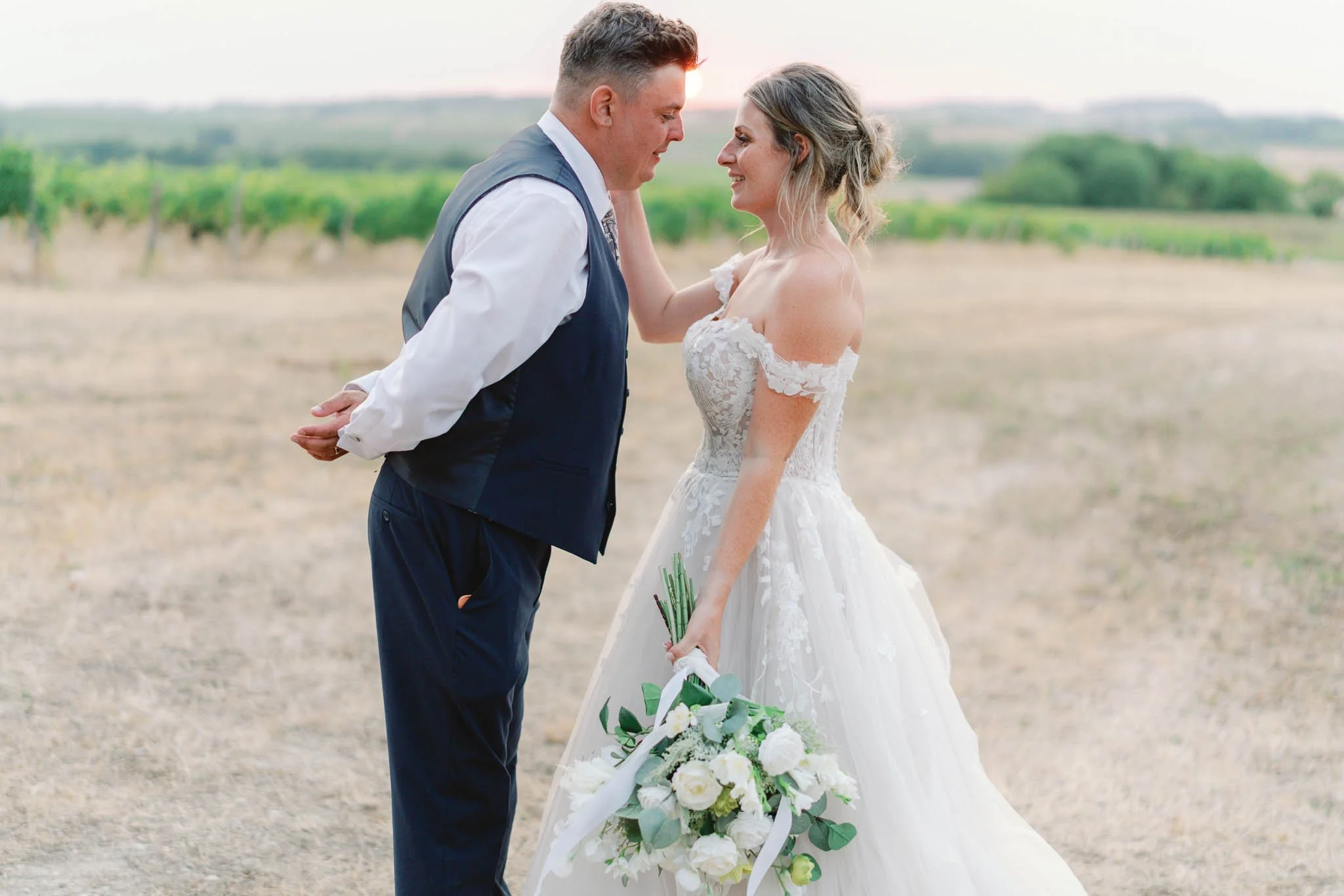 Bride and groom at sunset in a vineyard field at Paradis des Vignes, Charente