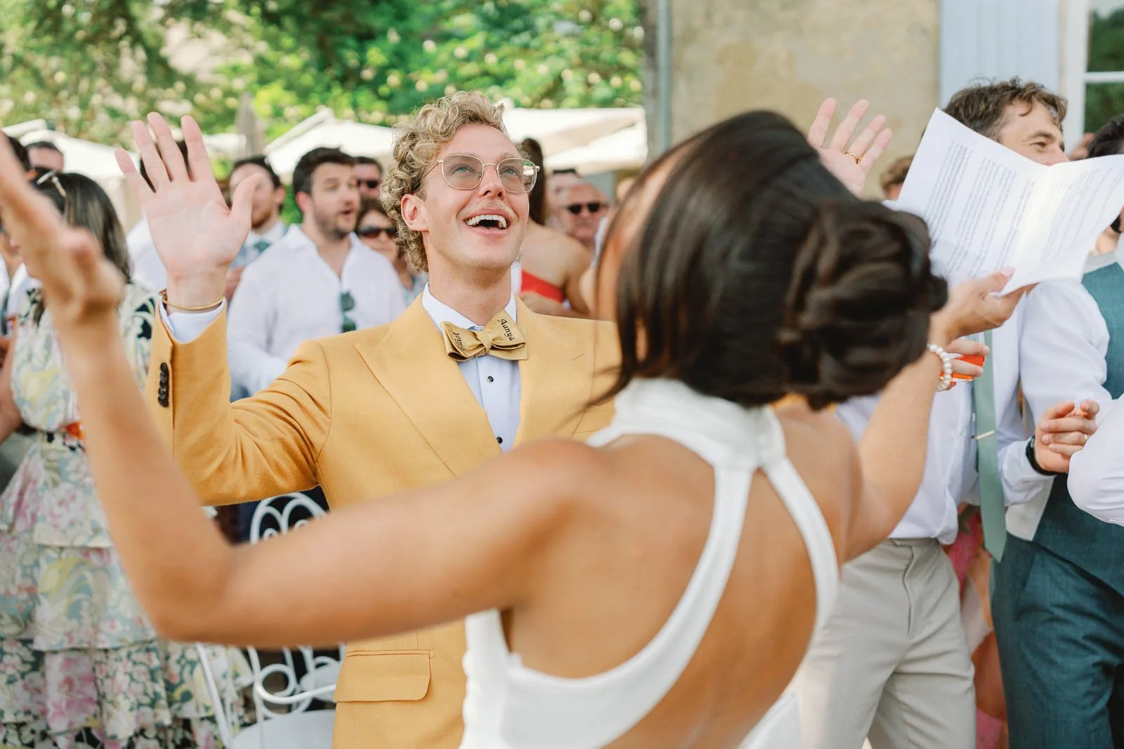 Bride dancing with guests on the terrace at Château Lagorce, Bordeaux