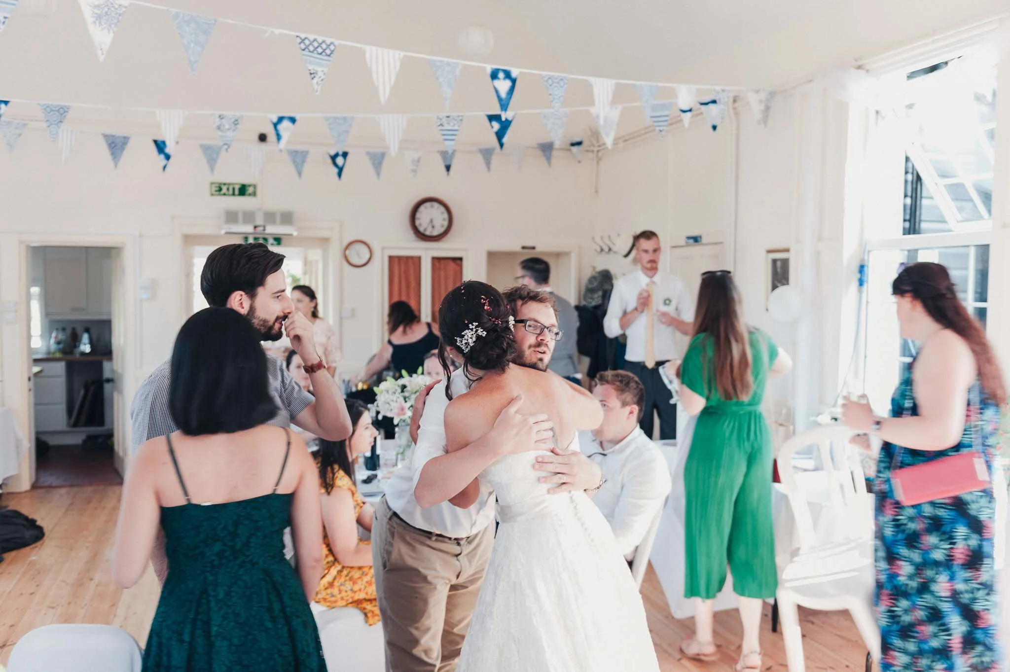 The bride hugging a guest during the start of the indoor reception.