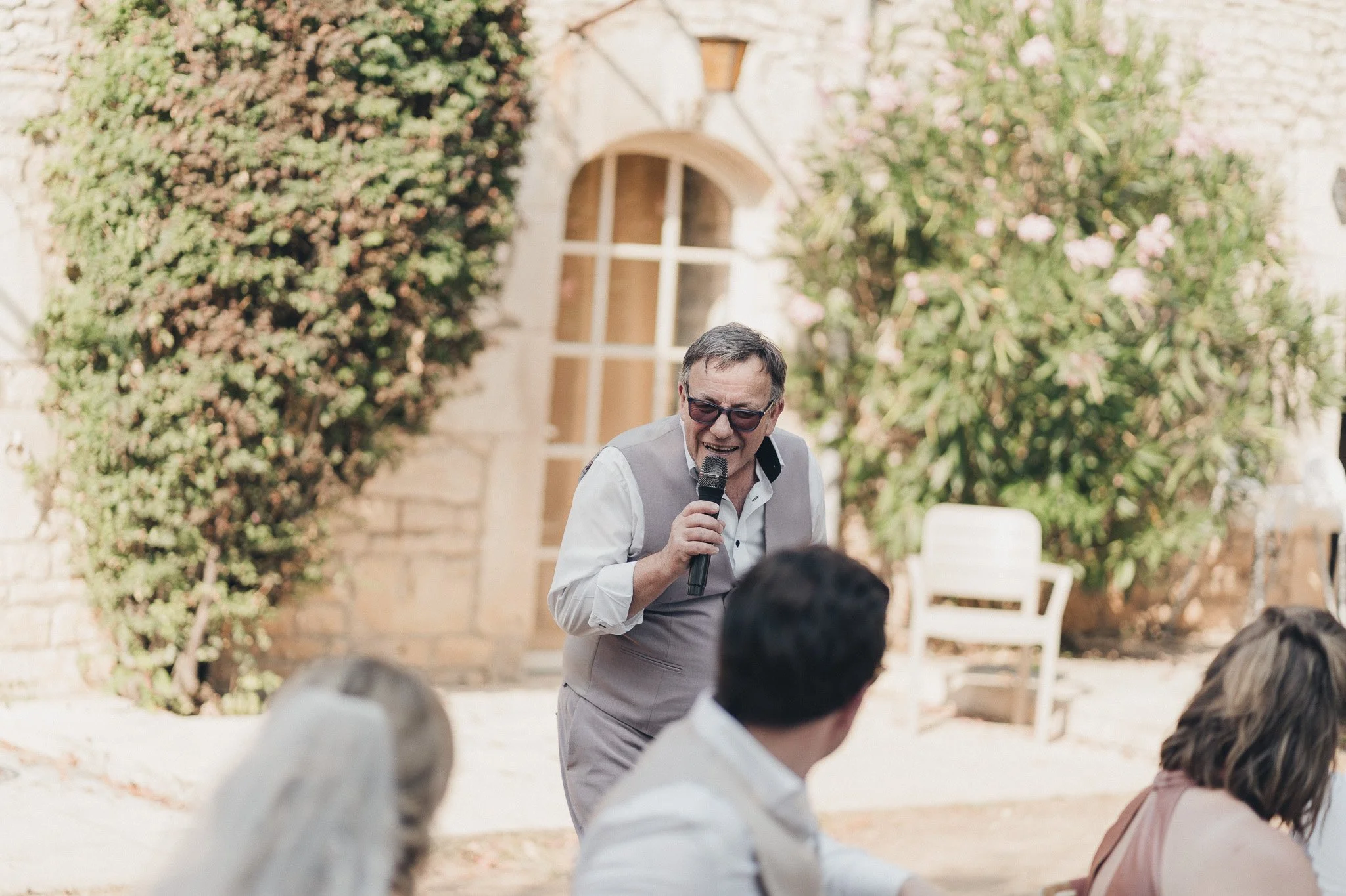Wedding speech being read during the outdoor reception at a Dordogne château