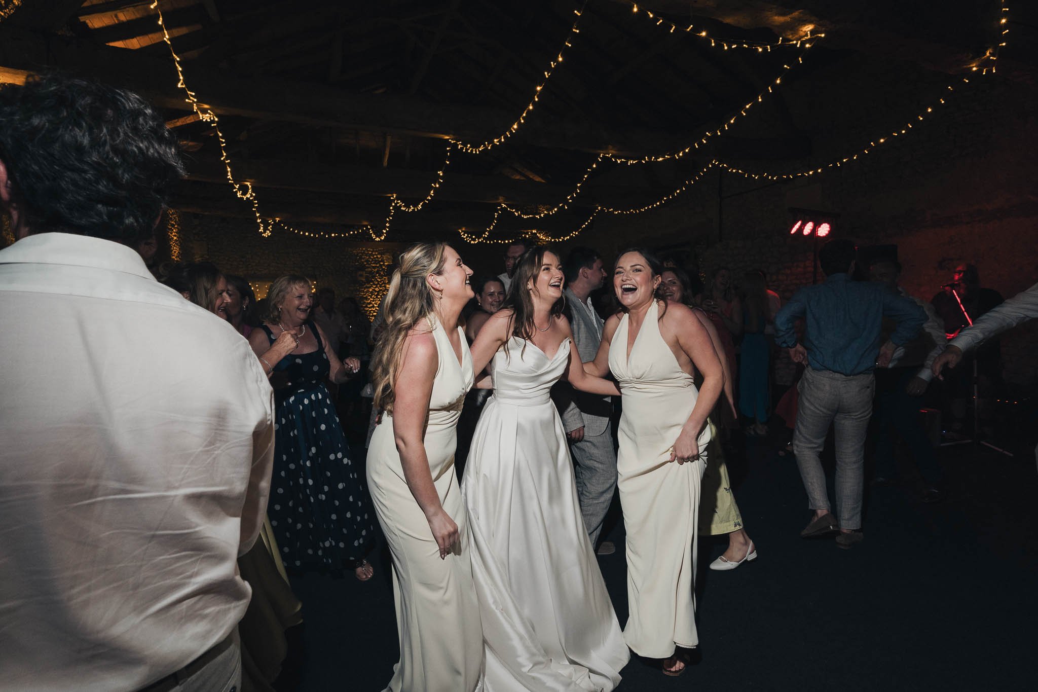 Bridesmaids dancing together on the dancefloor during the wedding party.