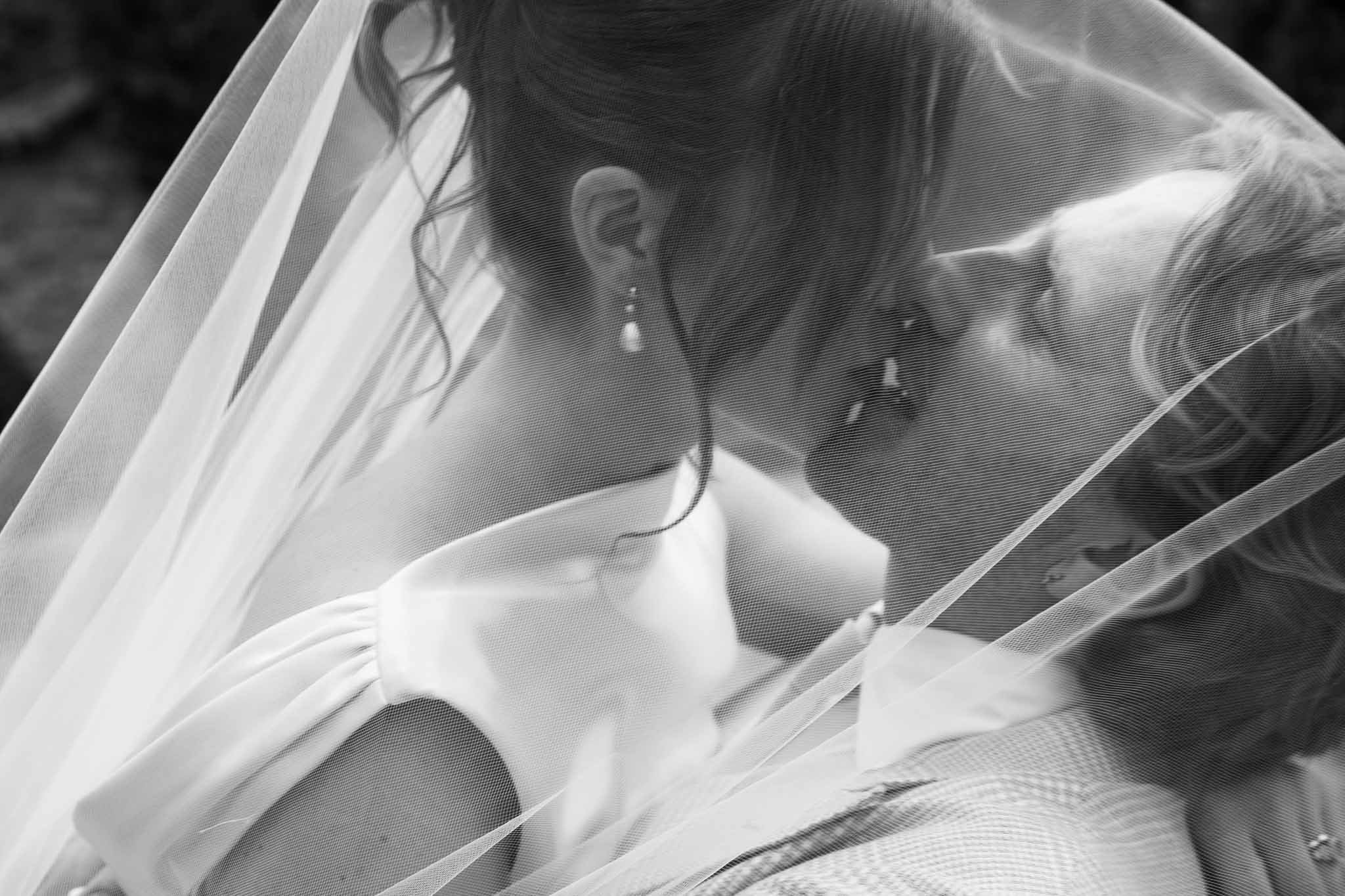 Intimate black and white portrait of bride and groom under veil, Southwest France wedding photography