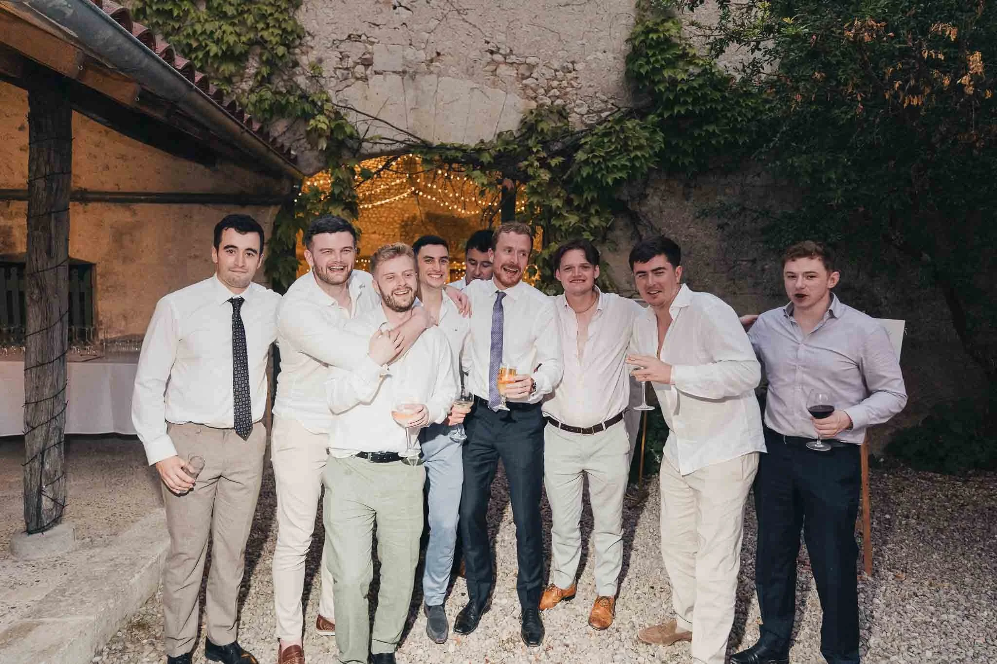 Group of friends posing together in the courtyard during the evening celebrations.