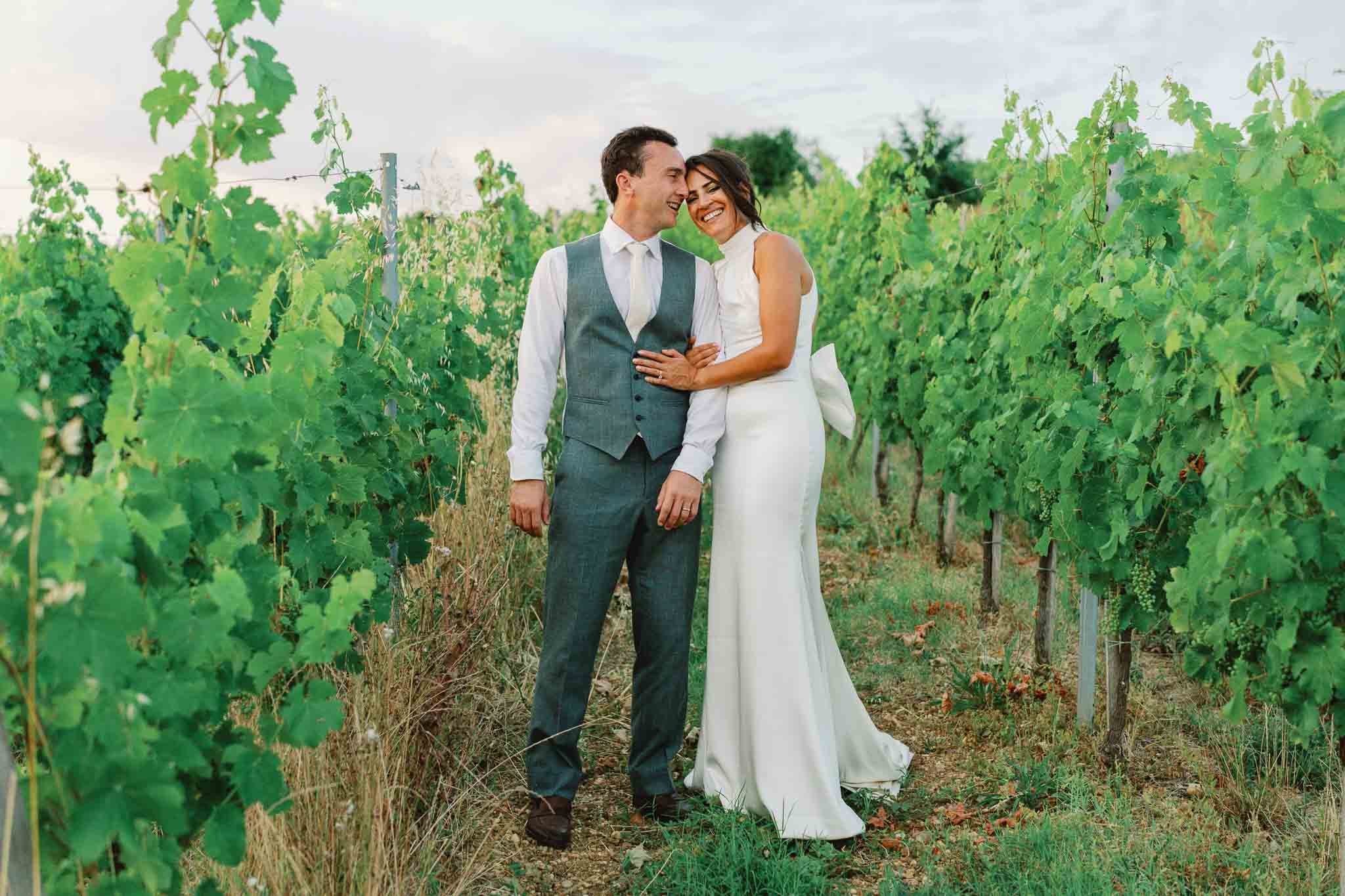 Bride and groom laughing together in a Bordeaux vineyard, Southwest France wedding photography