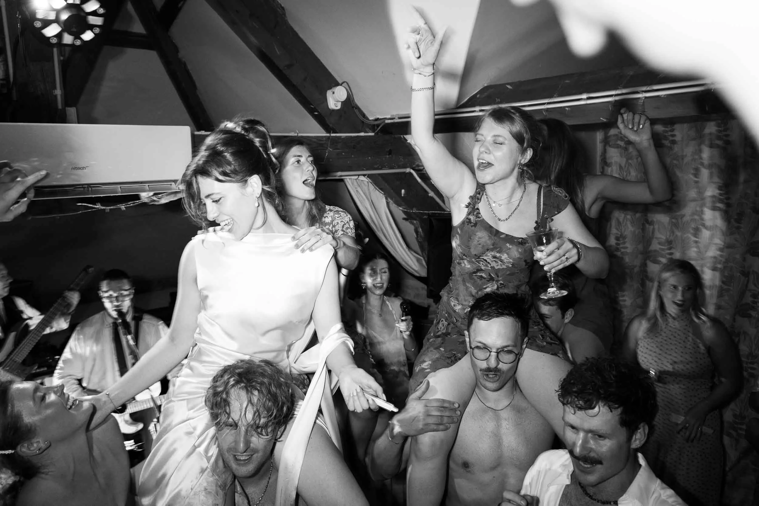 Black and white photograph of guests dancing at Château du Raysse, Dordogne