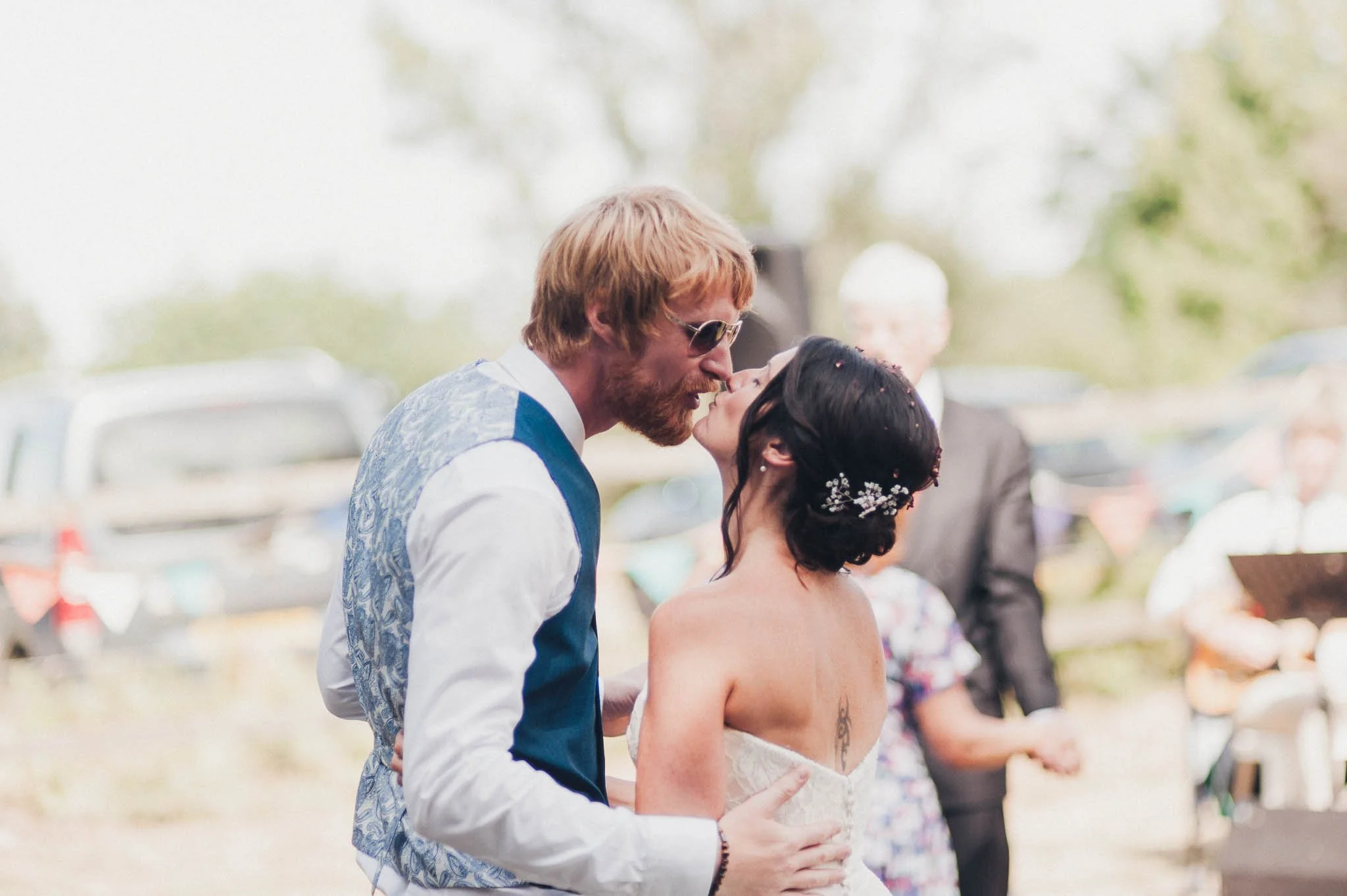 The bride and groom sharing a kiss during the outdoor reception.
