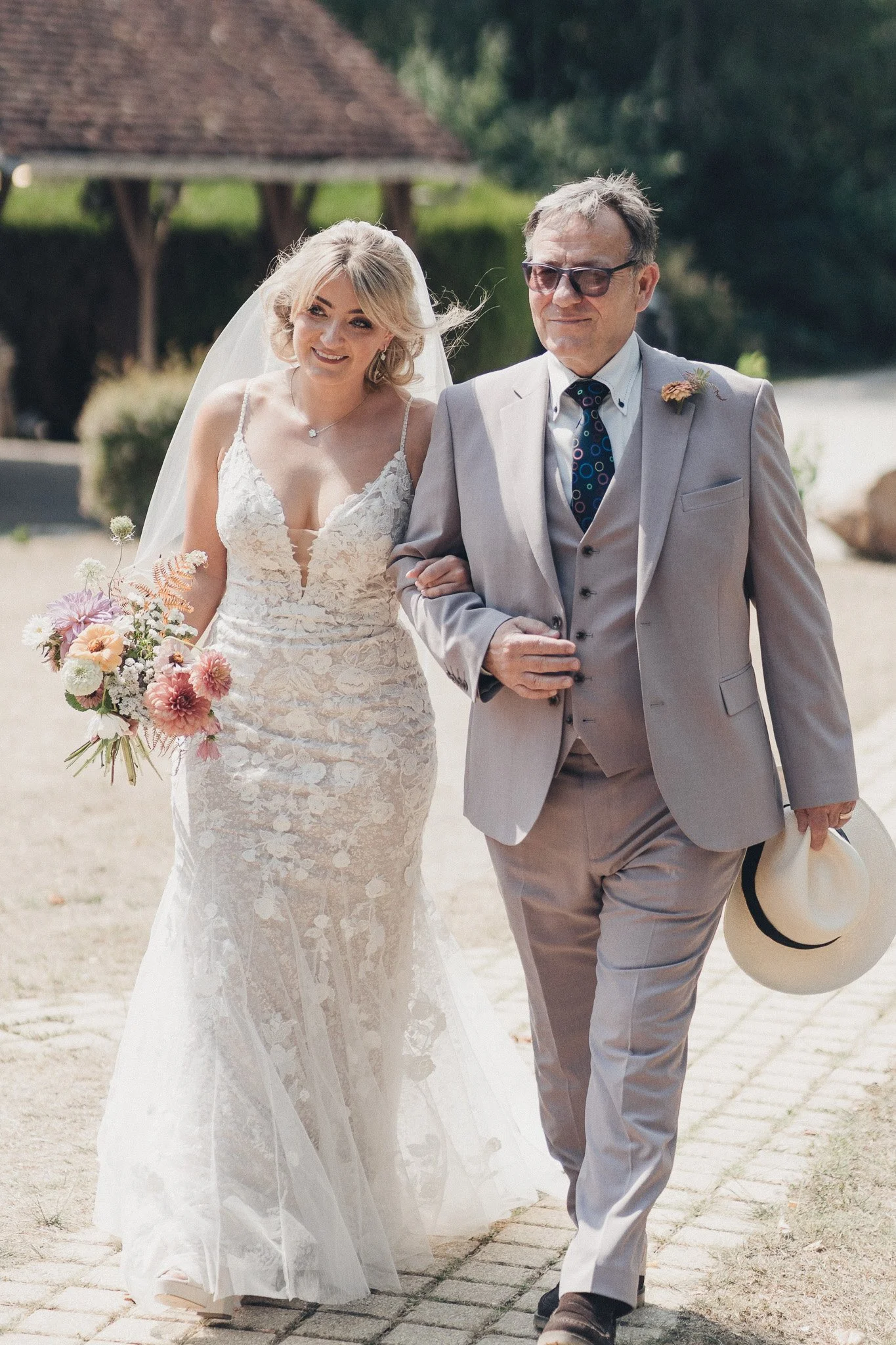 Bride and her father walking together before the ceremony at a Dordogne château.