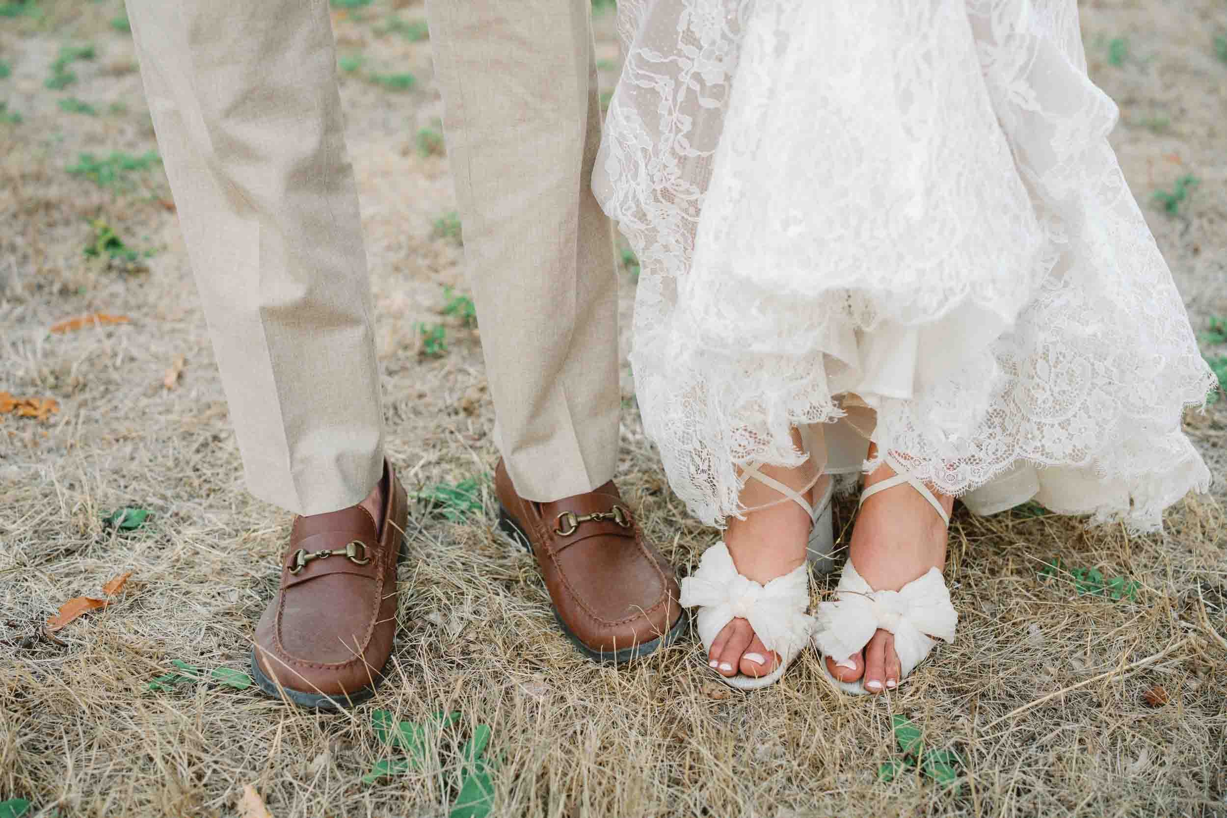 Bride and groom's feet together in the grass at Château de Sainte Croix, Dordogne