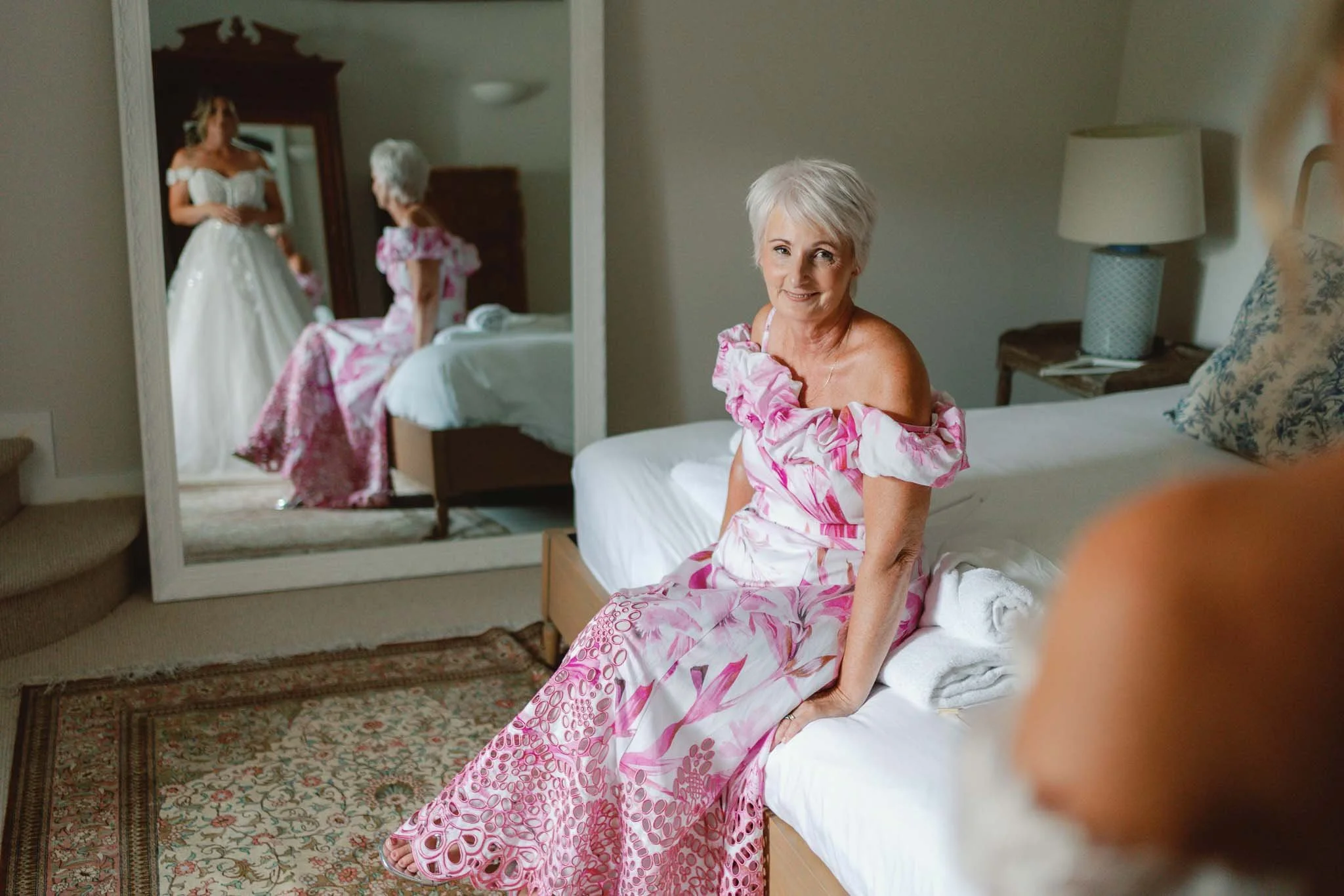 Mother of the bride in a pink dress in a candid bedroom moment at Paradis des Vignes, Charente