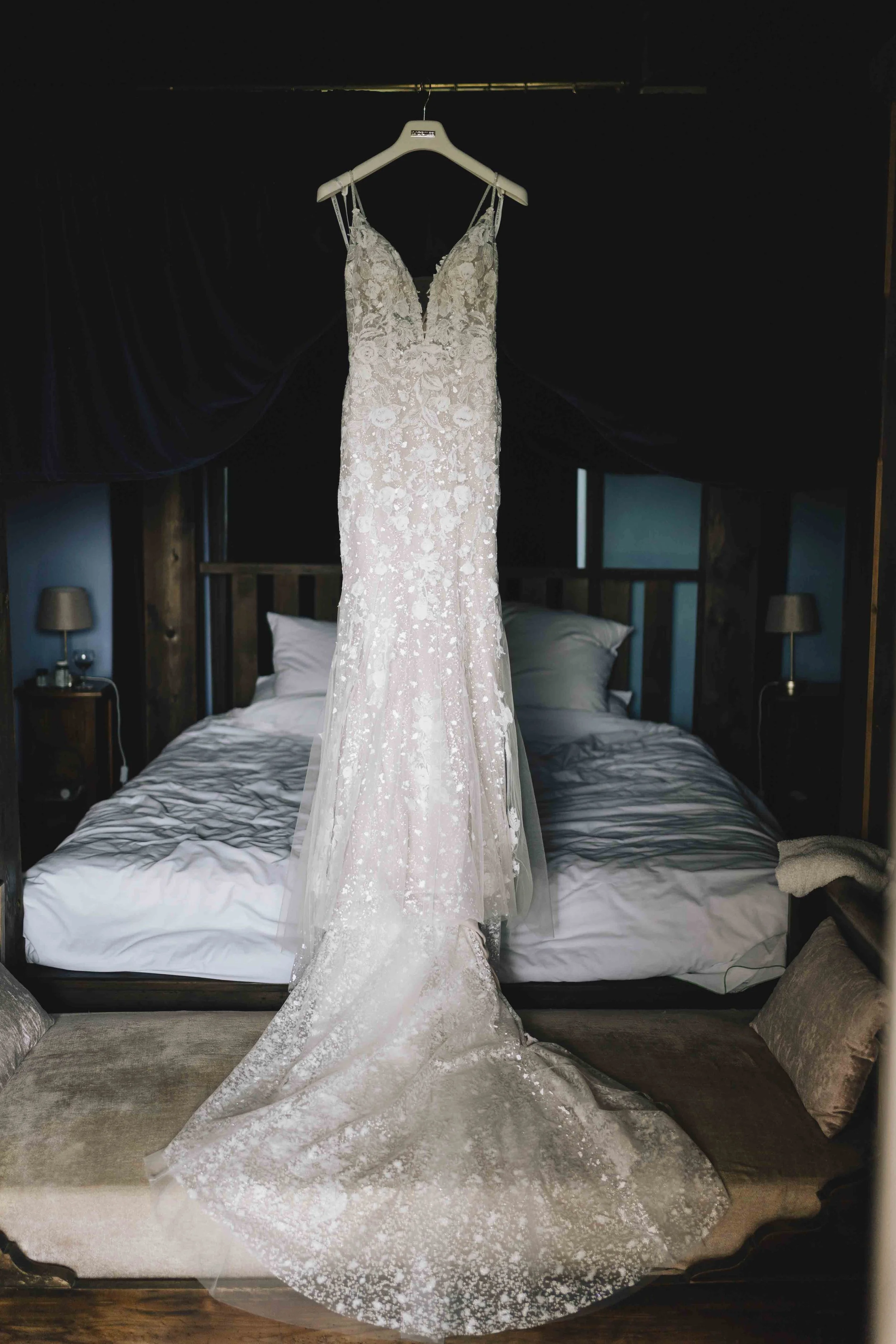 Wedding dress hanging in a rustic château bedroom in the Dordogne, photographed by Gavin Chapman Photography