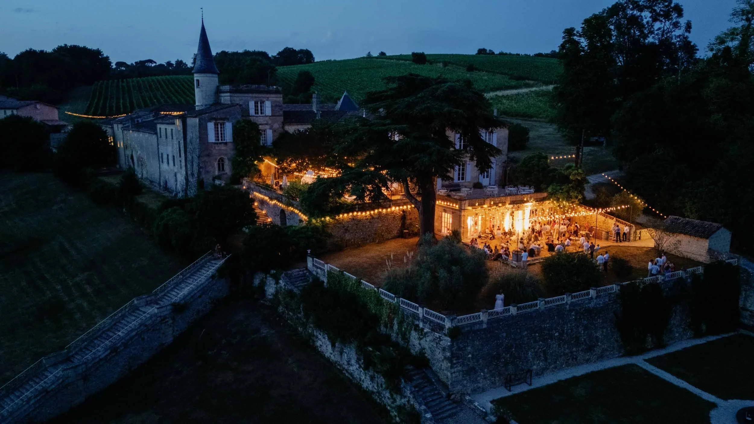 Aerial drone photograph of Château Lagorce lit up at night, Bordeaux