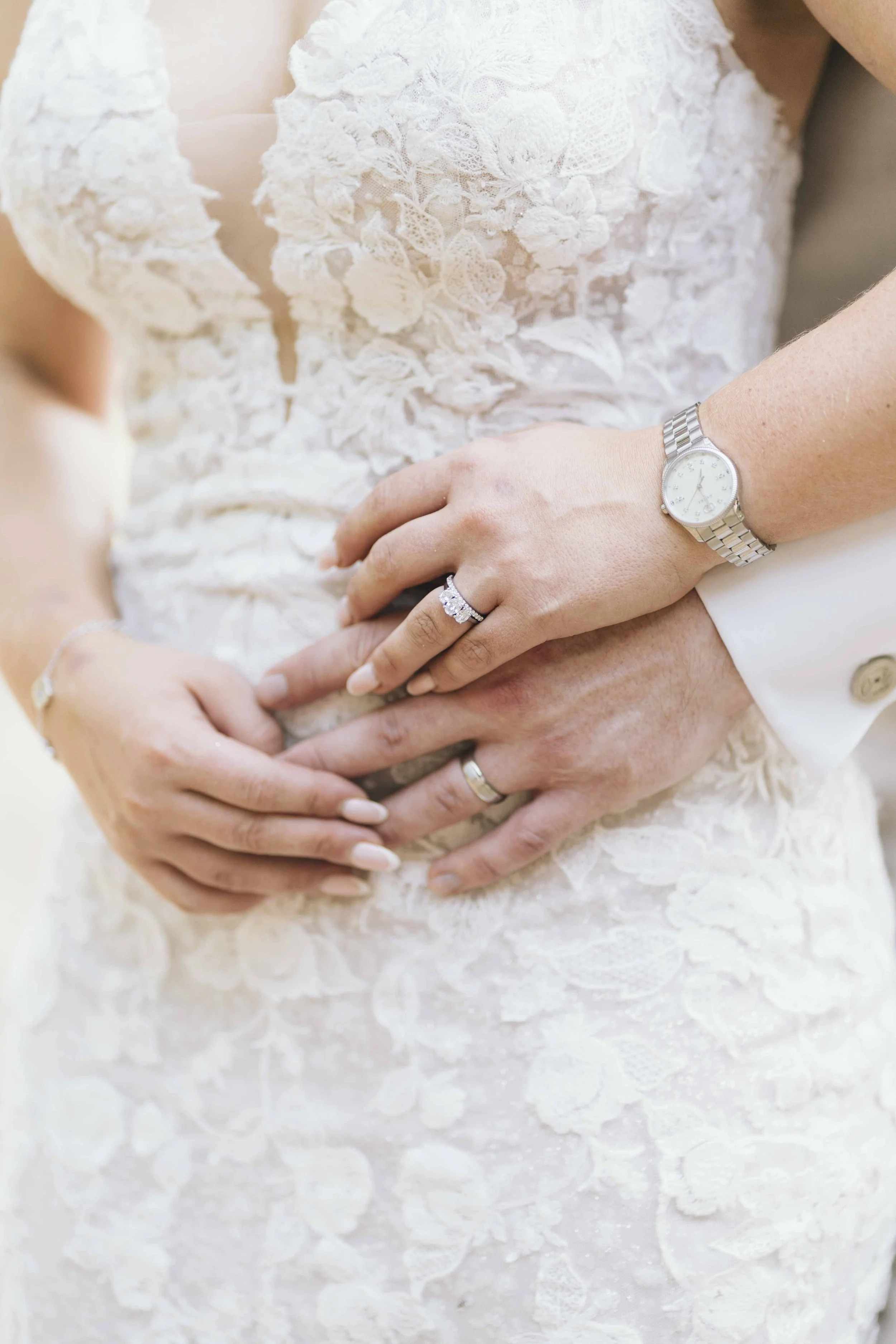 Close-up of bride and groom’s hands and wedding rings at a château wedding in the Dordogne, France