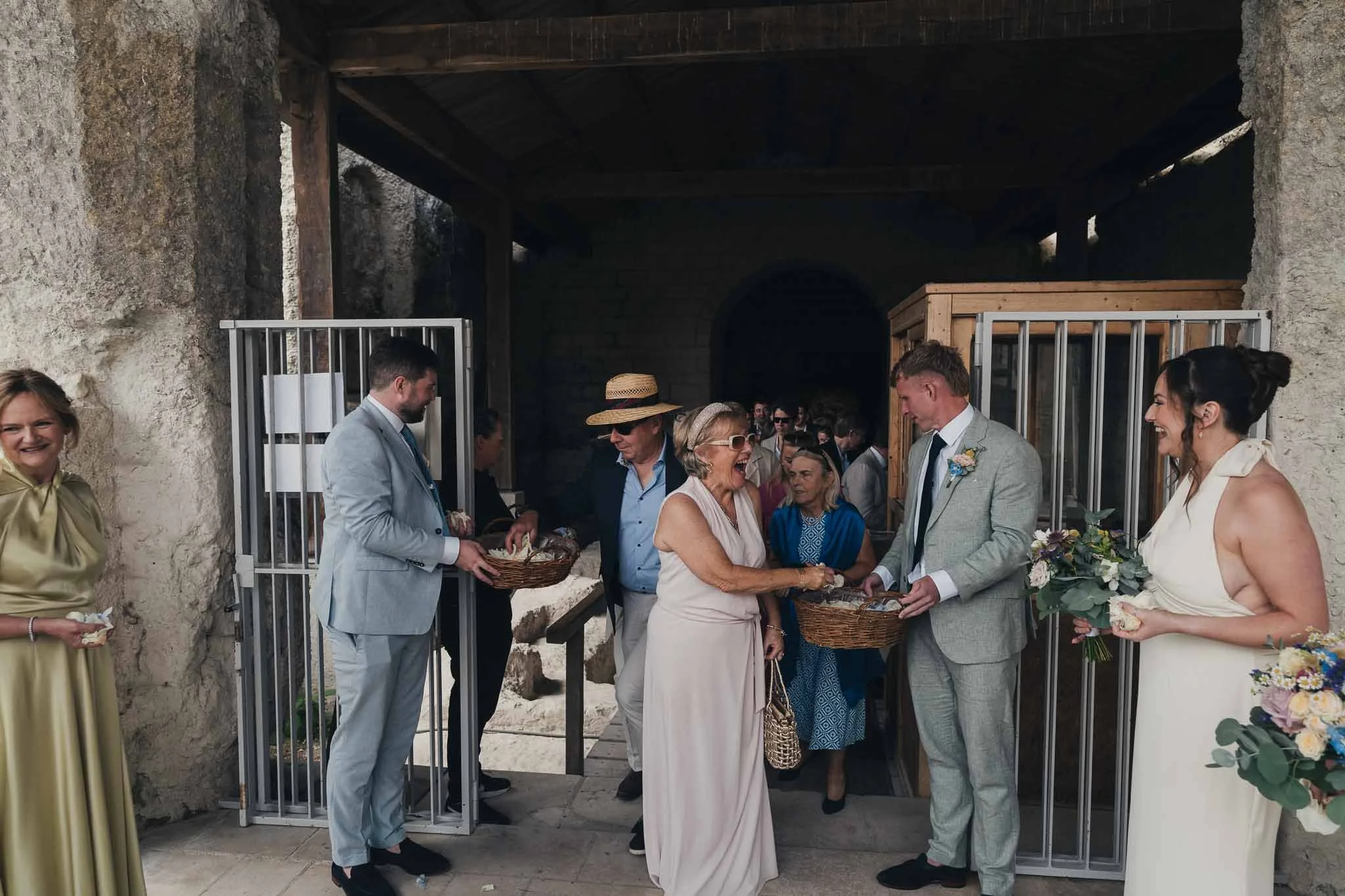 Guests handing out confetti cones outside the Église Souterraine Saint-Jean before the couple exit.