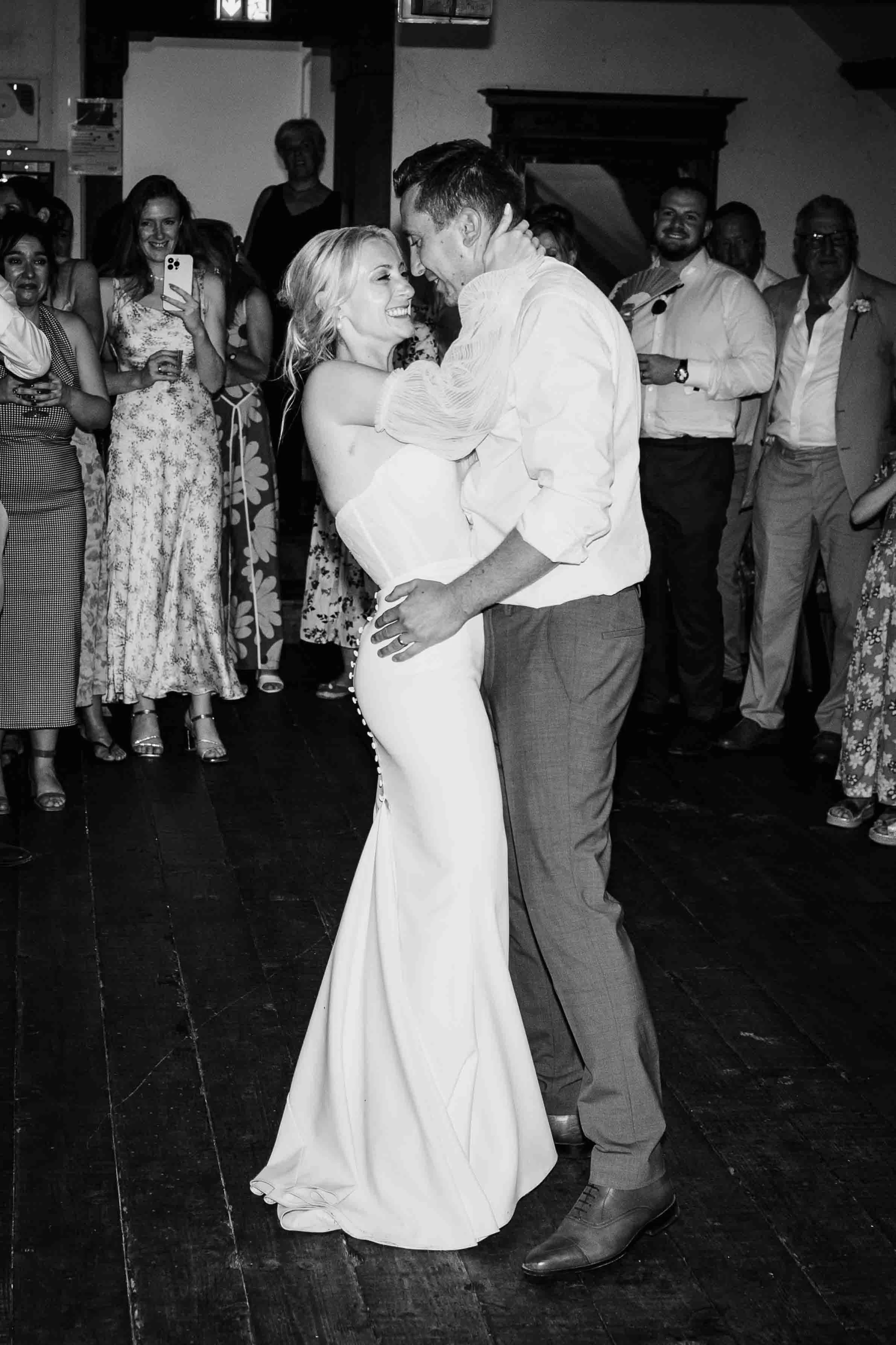 Bride and groom sharing their first dance surrounded by guests at Château du Raysse