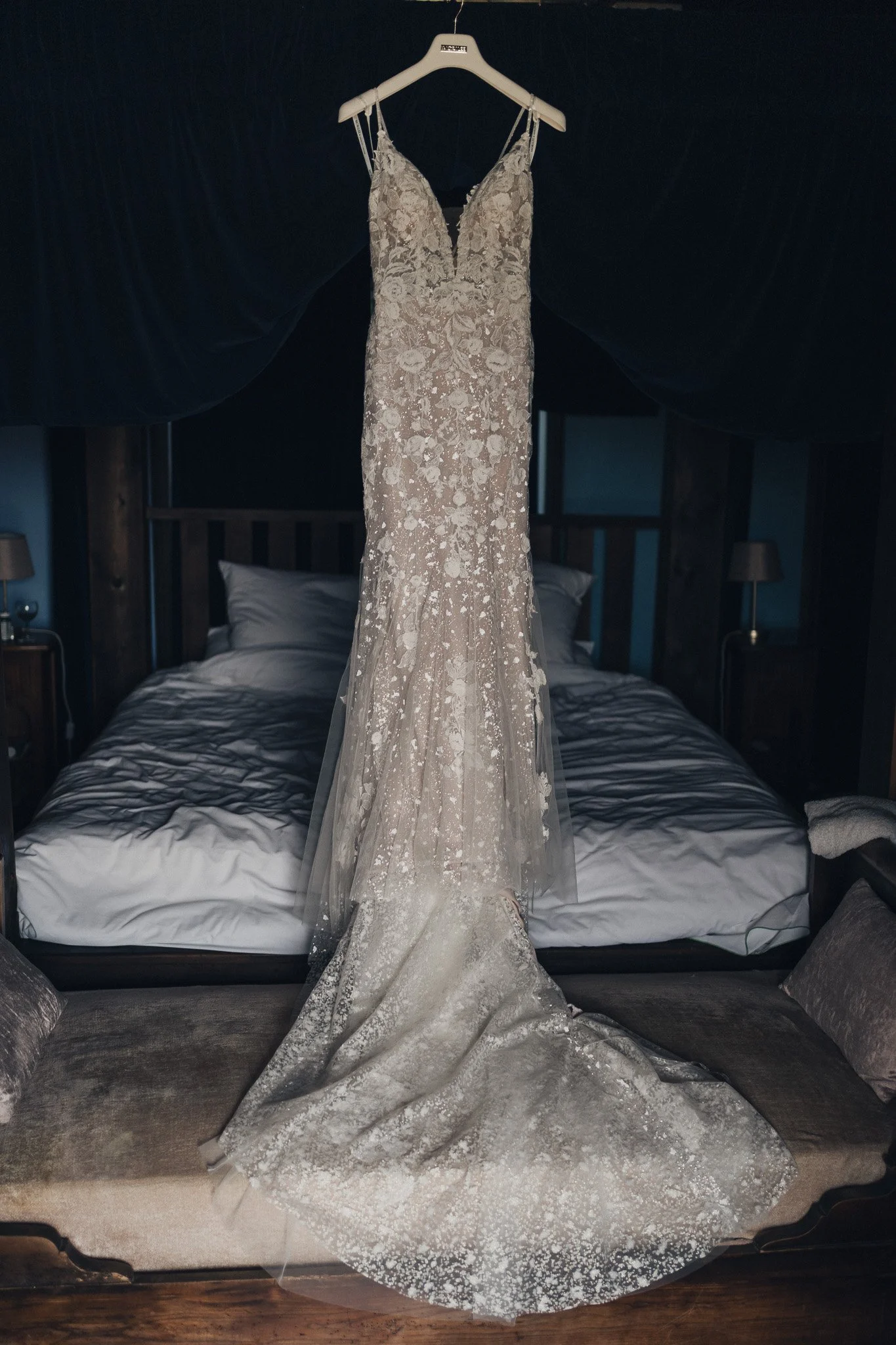 Wedding dress hanging above the bed in the bridal suite.