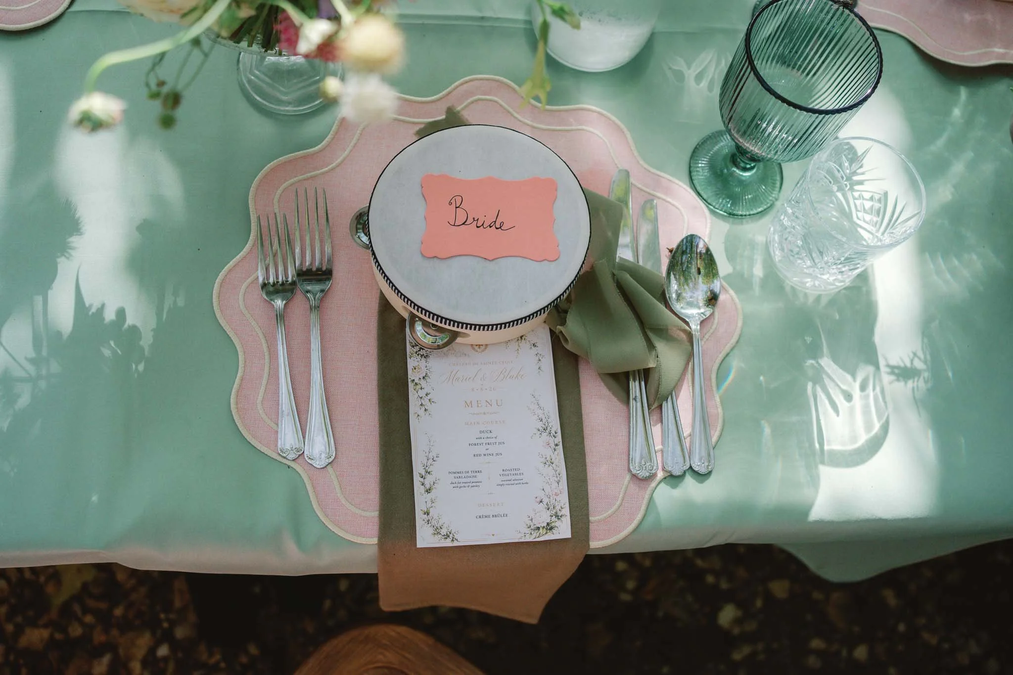 Flatlay of a wedding place setting with a "Bride" place card at Château de Sainte Croix, Dordogne