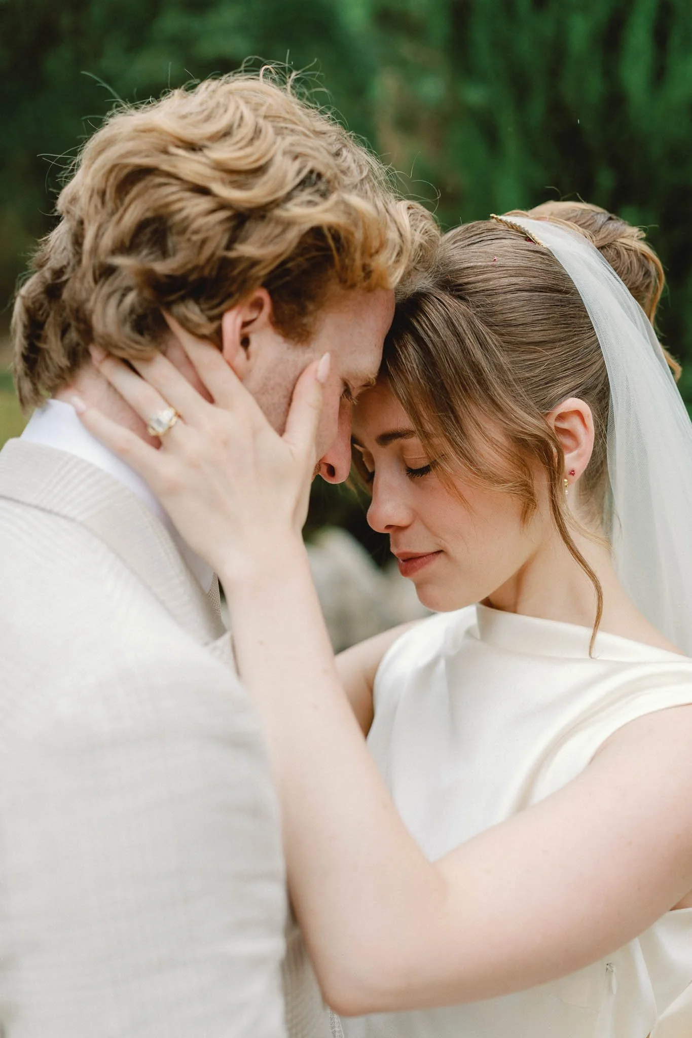 Bride and groom sharing a tender candid moment at Château du Raysse, Dordogne