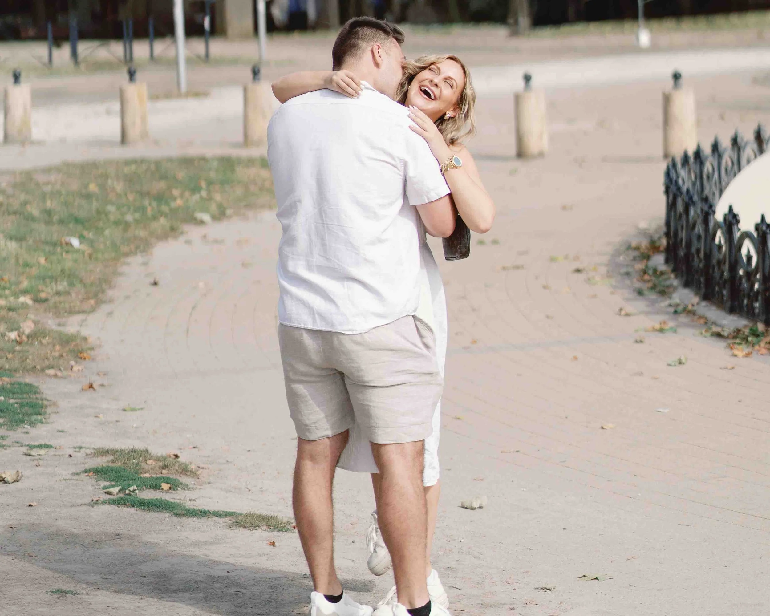 Woman laughing as she hugs her new fiancé straight after he proposed in Bordeaux