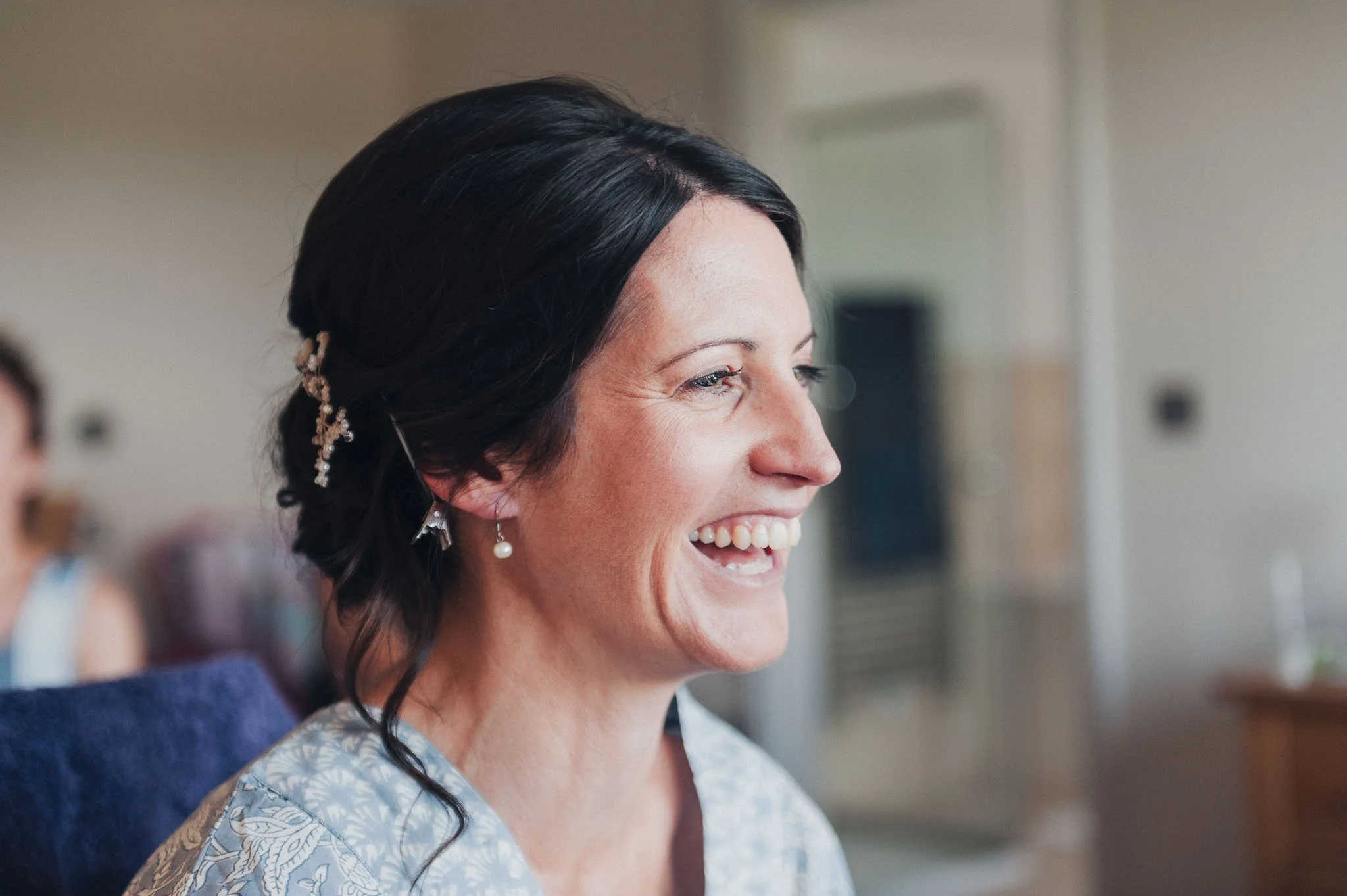 Natural close-up of the bride smiling during bridal prep.