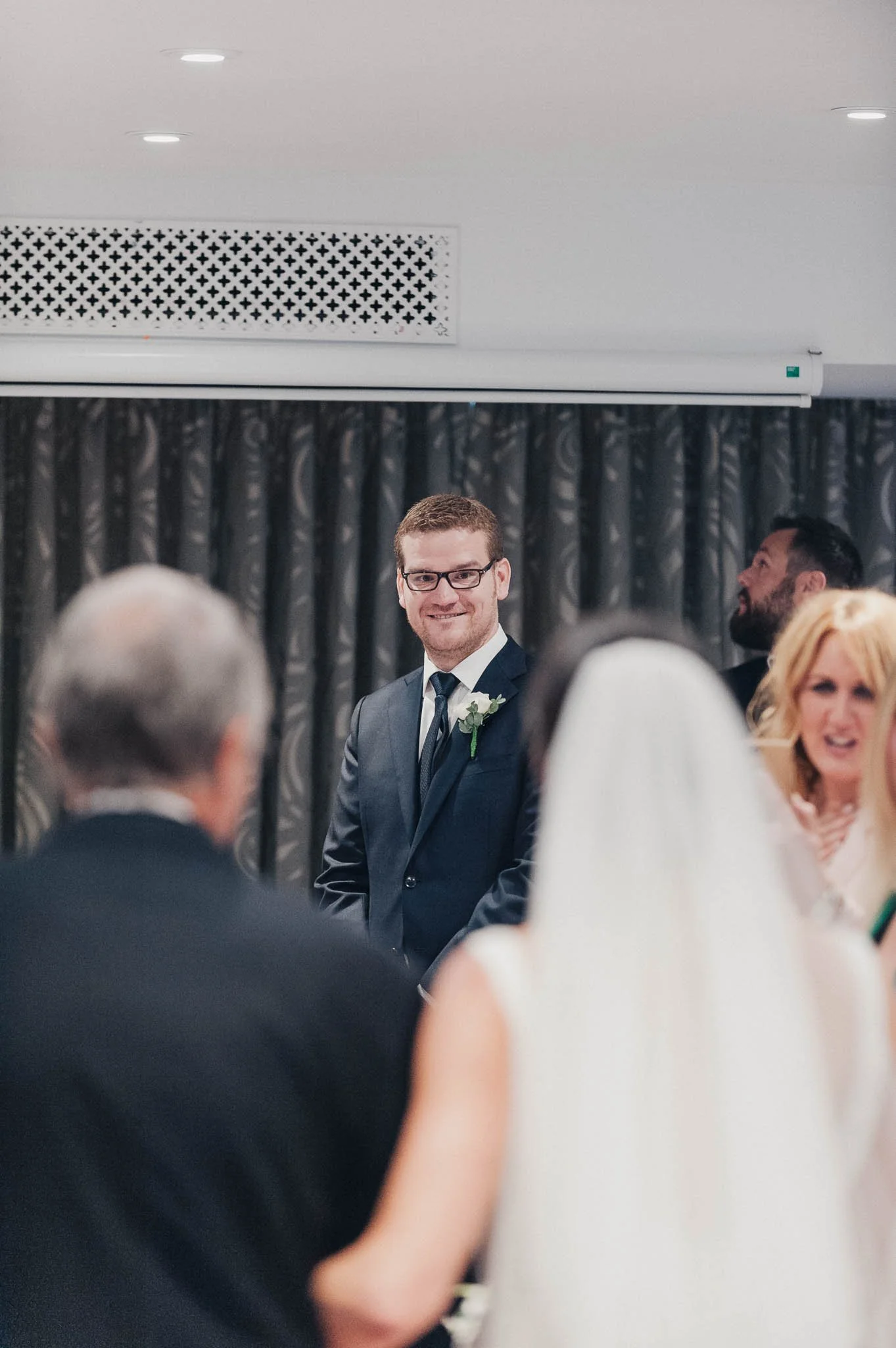 Groom and guests waiting at the front of the ceremony room at Richmond Hill Hotel.
