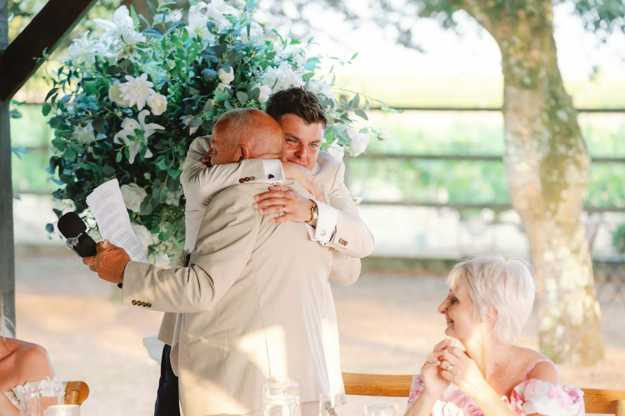 A family hug under the wisteria arch at Paradis des Vignes, Charente