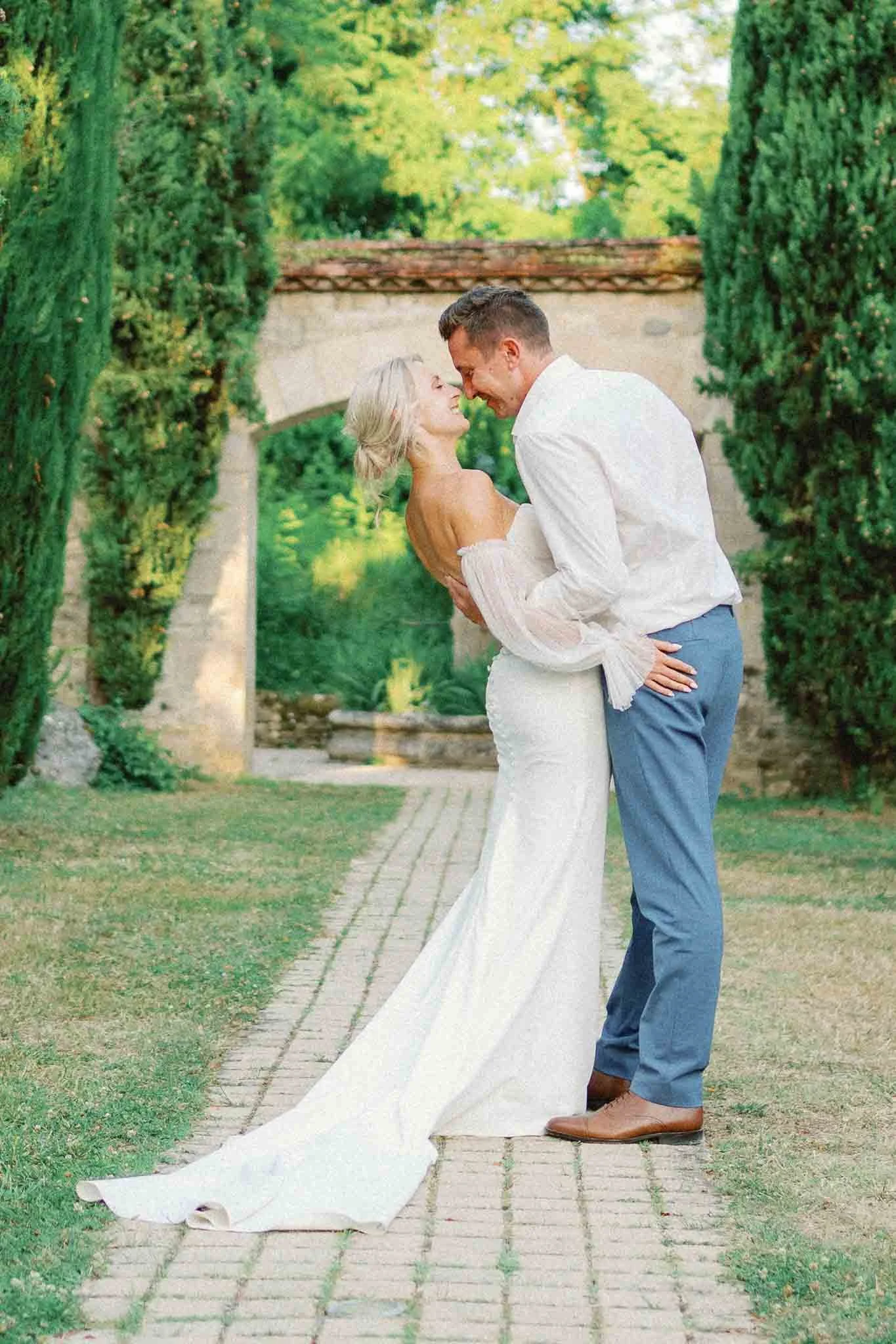 Groom dipping the bride for a kiss at Château du Raysse, Dordogne