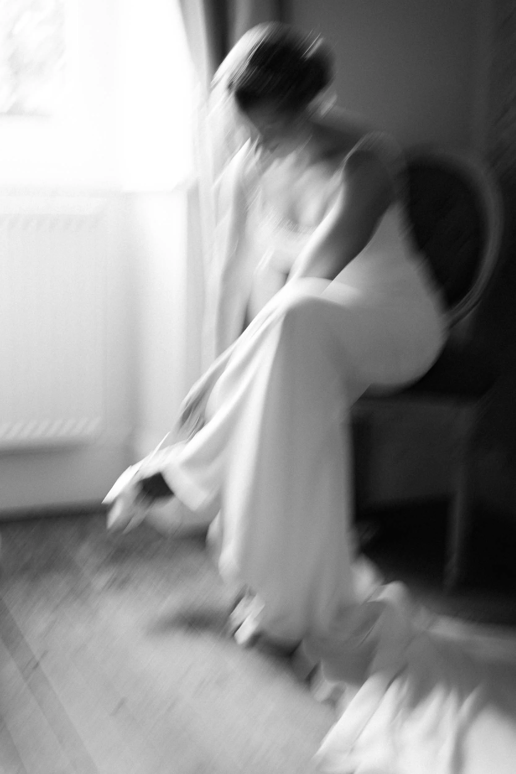 Backlit black and white photograph of the bride in motion at Manoir de Longeveau, Charente