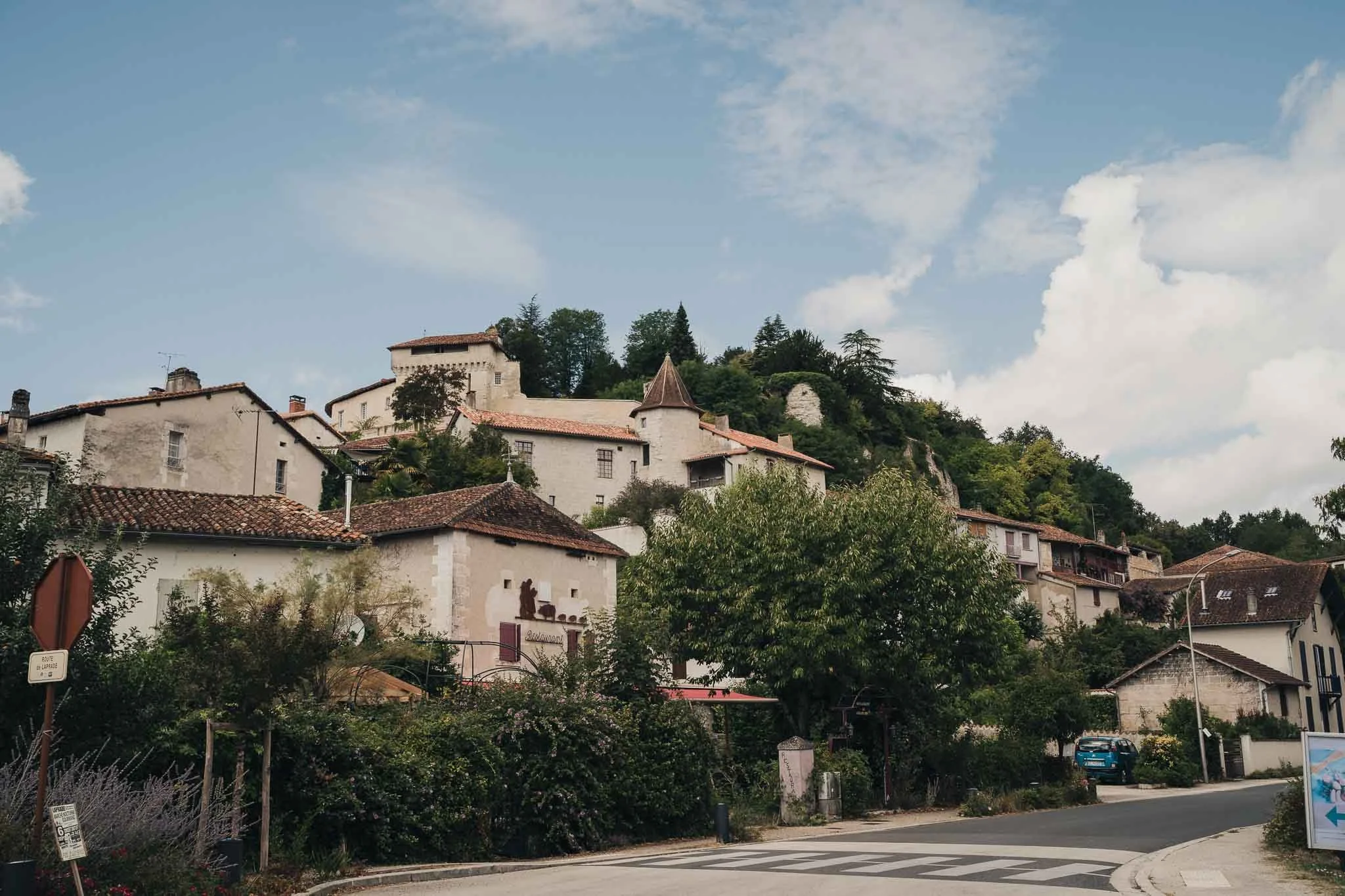 View of the village of Aubeterre-sur-Dronne with stone houses and tiled roofs.