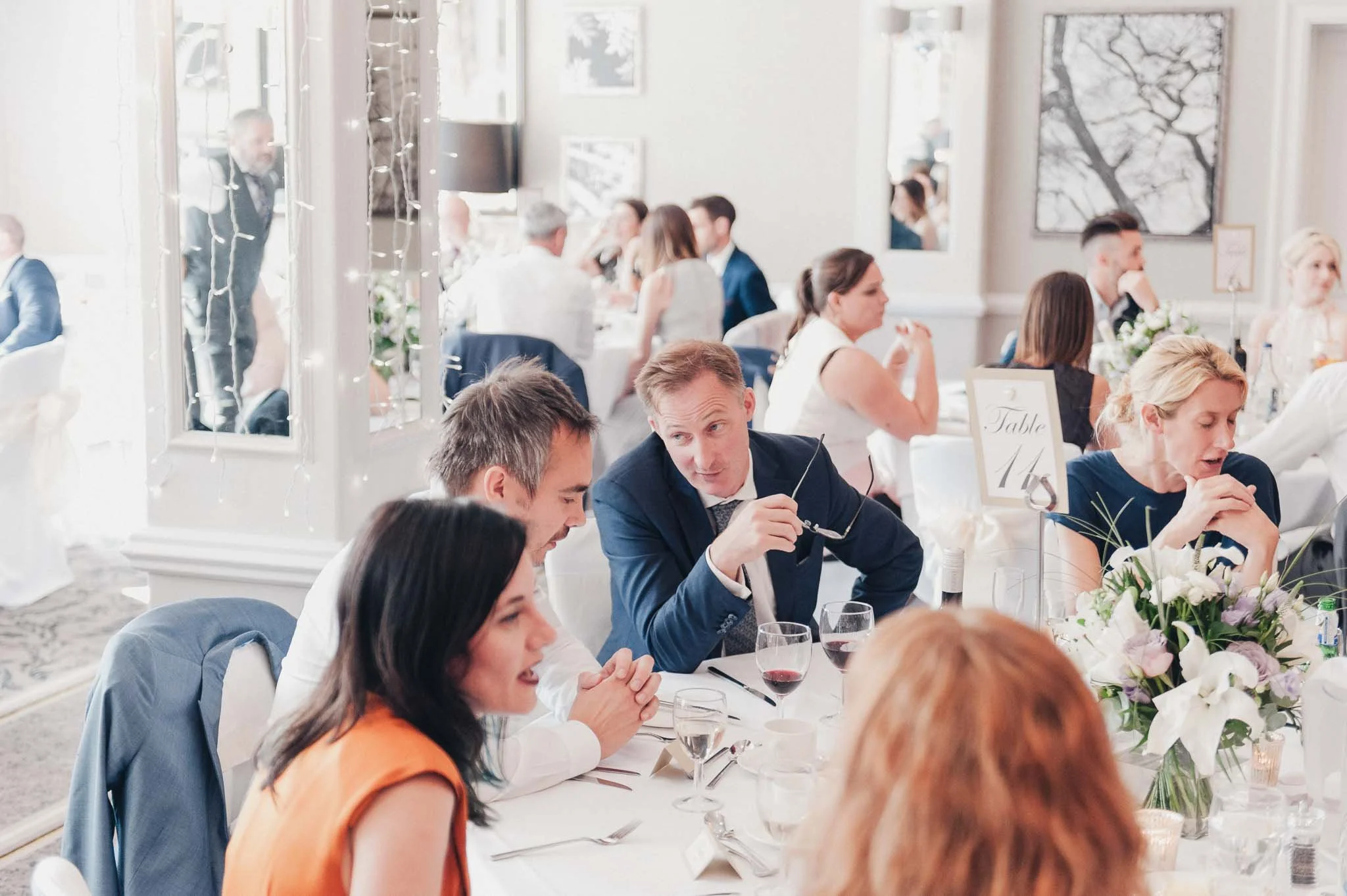 Guests chatting around their table during the wedding breakfast at Richmond Hill Hotel.