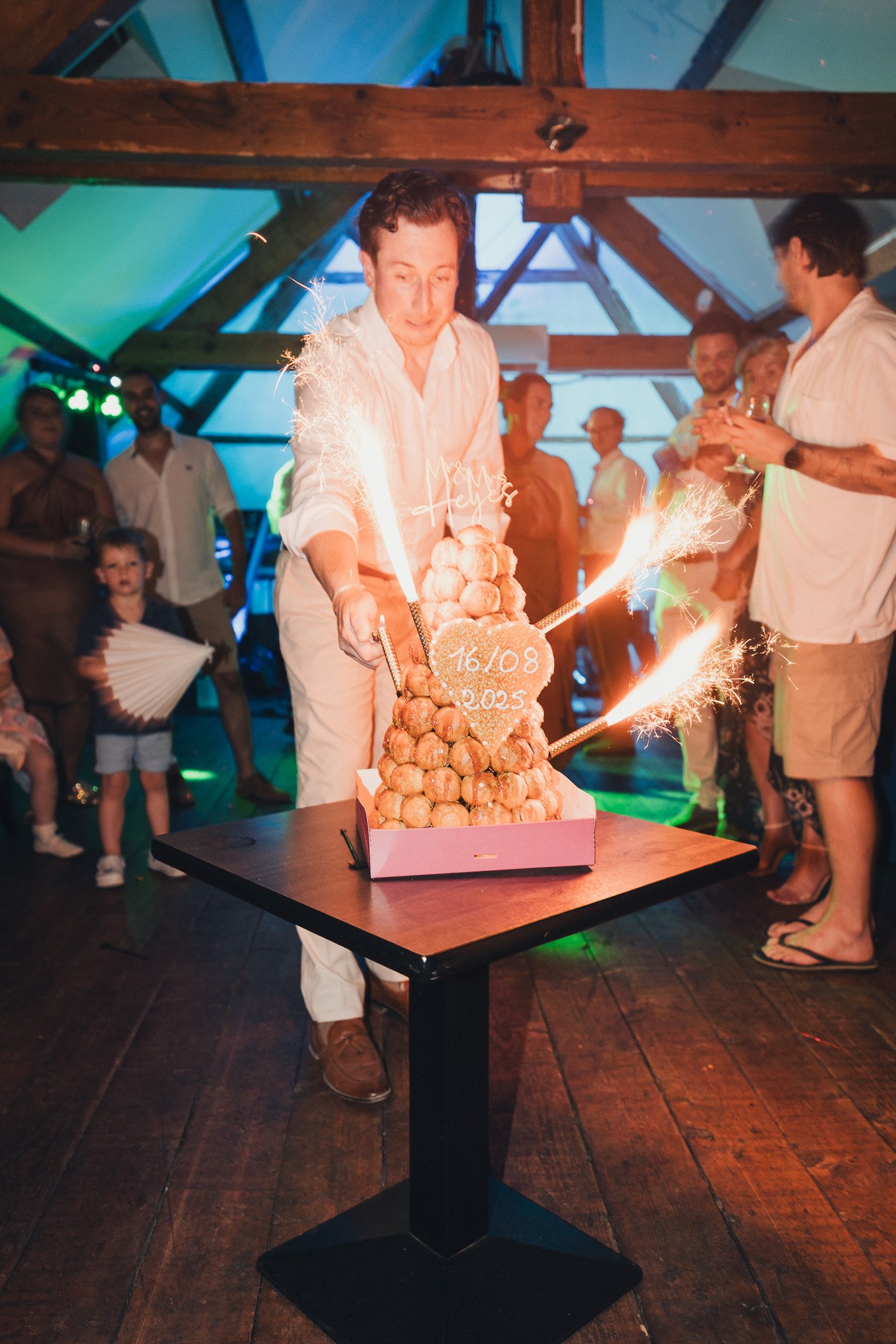 Wedding croquembouche presented with sparklers during the evening reception.