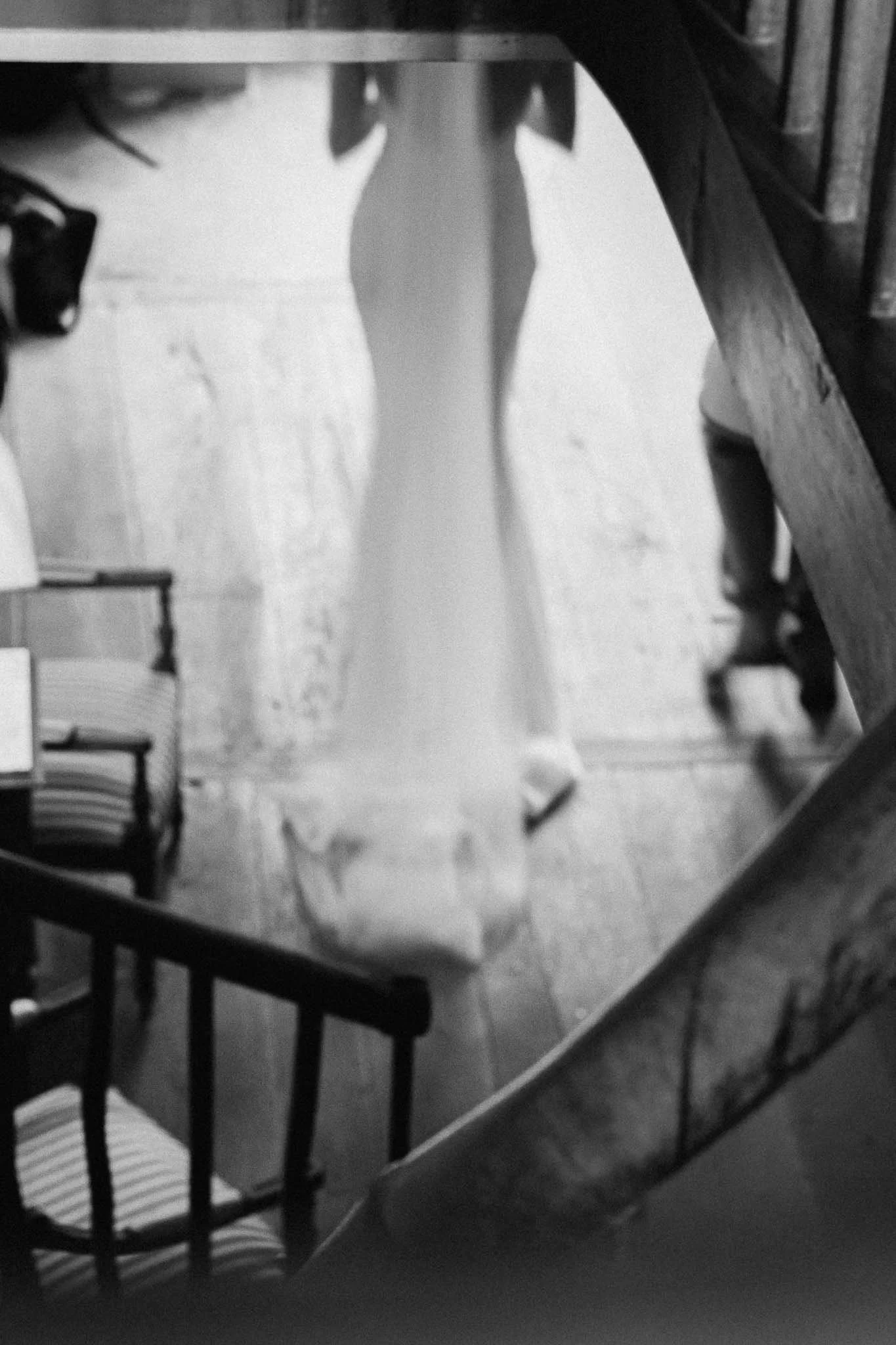 Black and white photograph of the bride walking to the ceremony at Manoir de Longeveau, Charente
