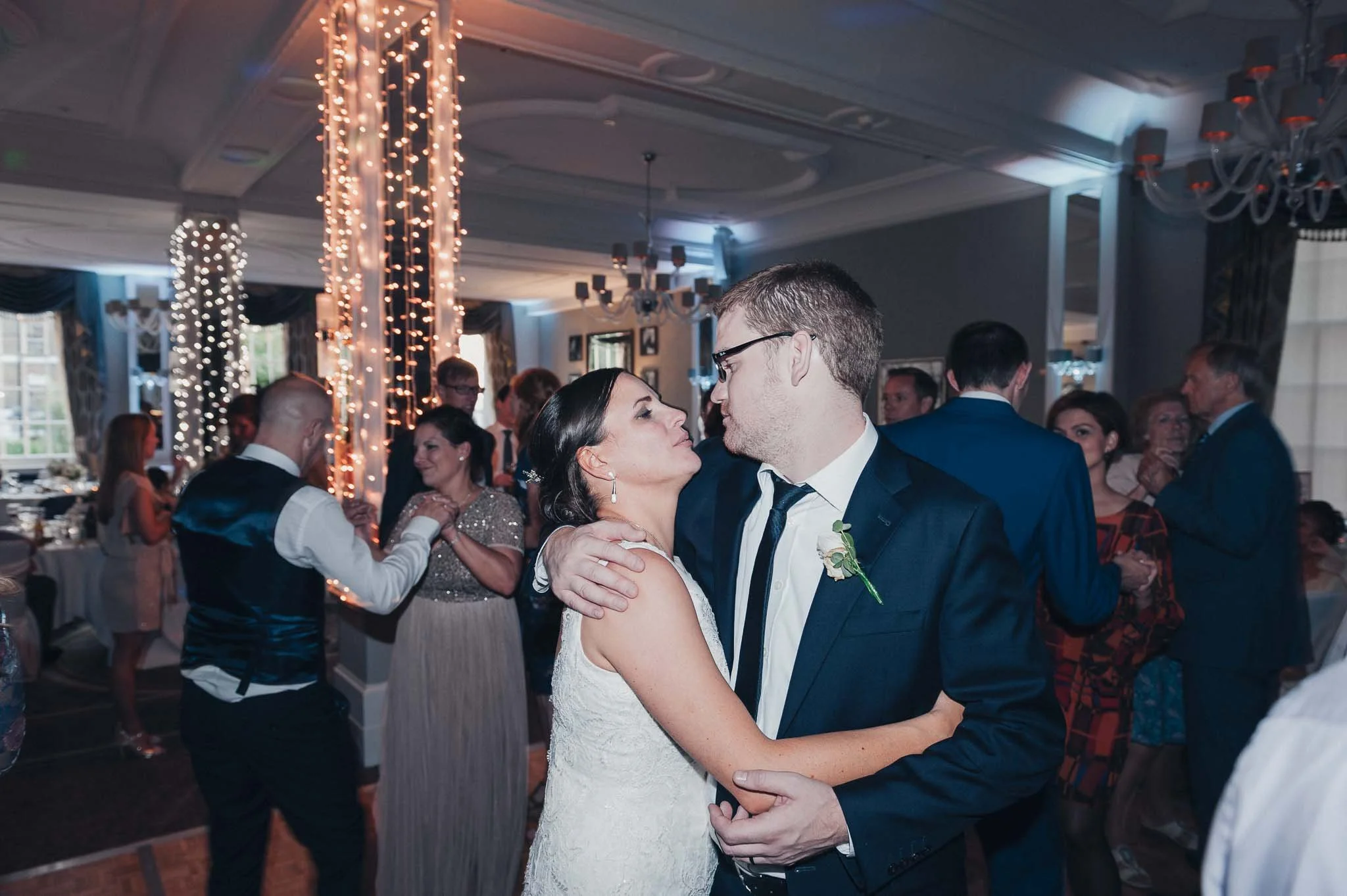 The couple smiling at each other while dancing during the evening reception.