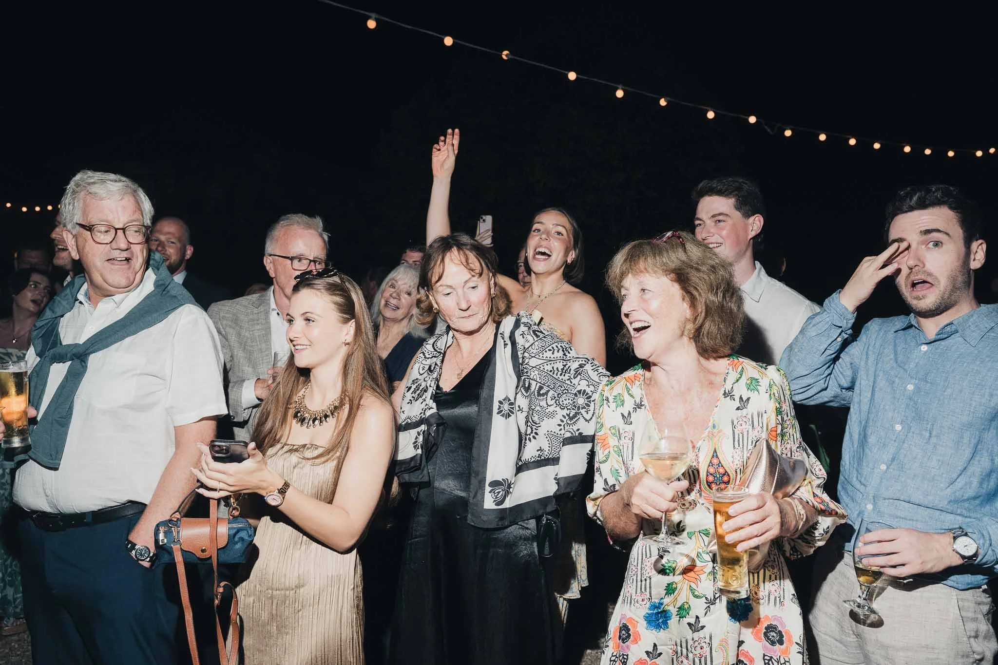 Guests reacting and cheering during the evening cake presentation.