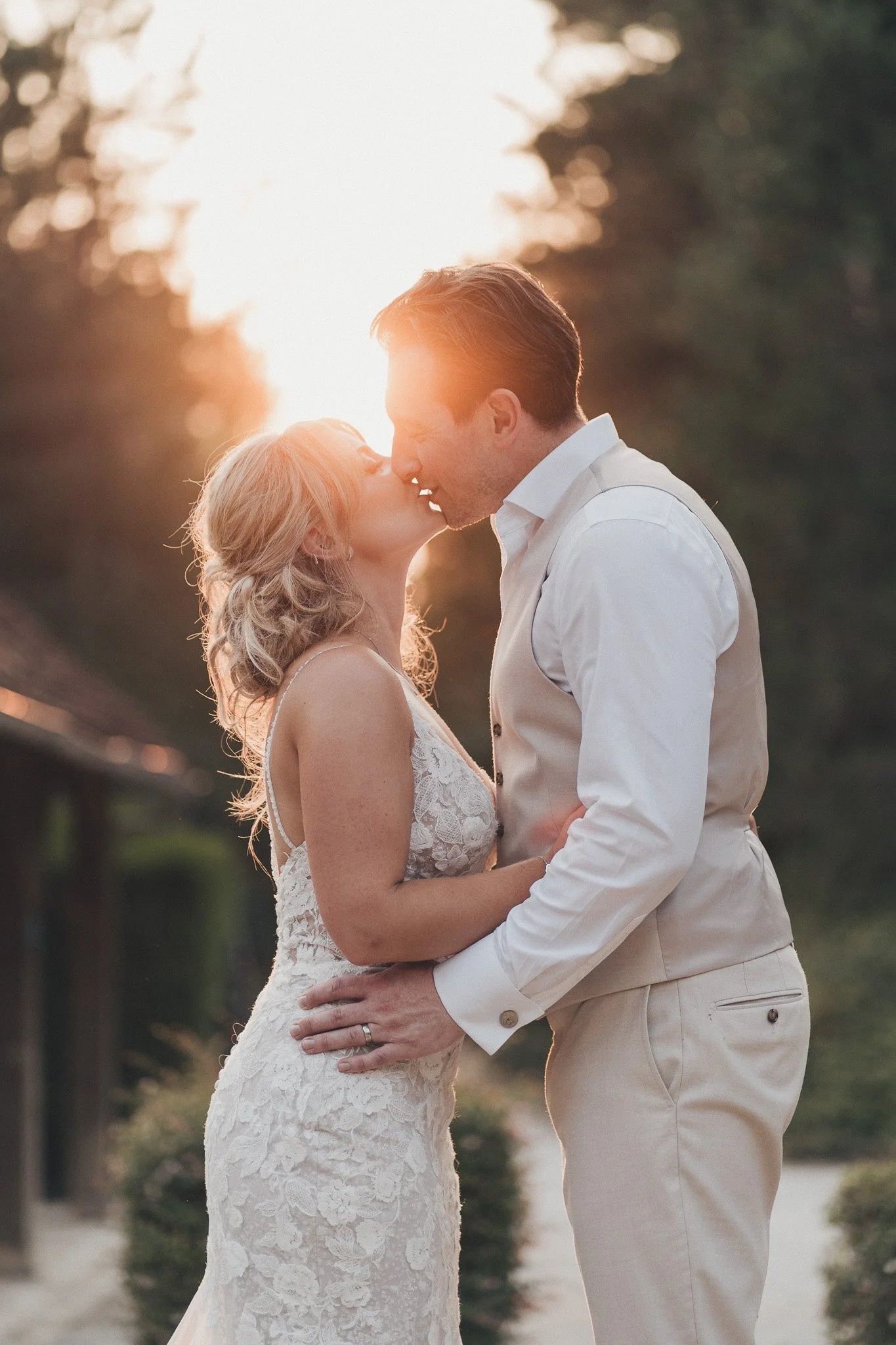 A couple sharing a golden hour kiss during their wedding portraits in southwest France.