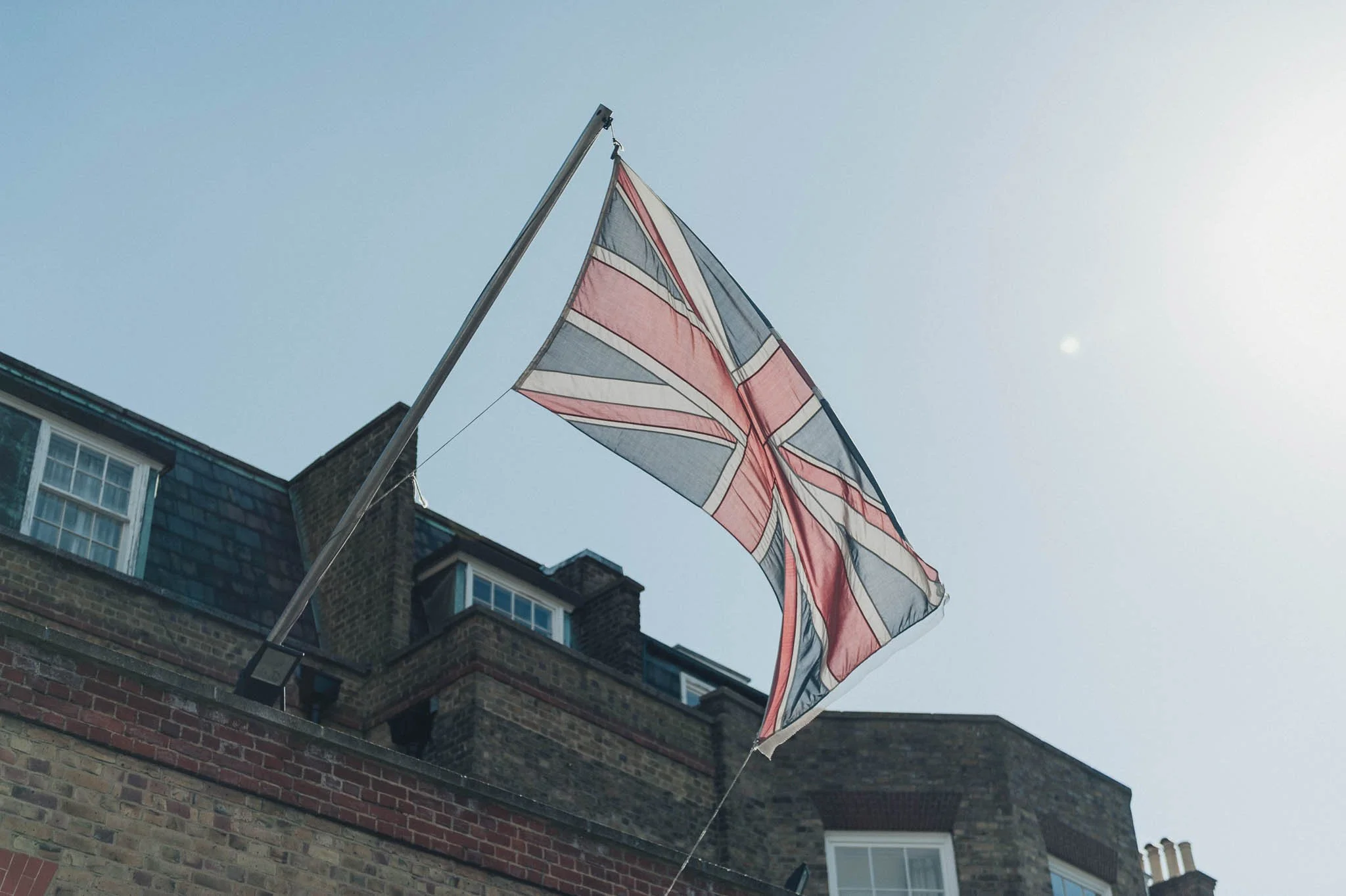 Union Jack flag flying above a building on a sunny morning before the wedding.
