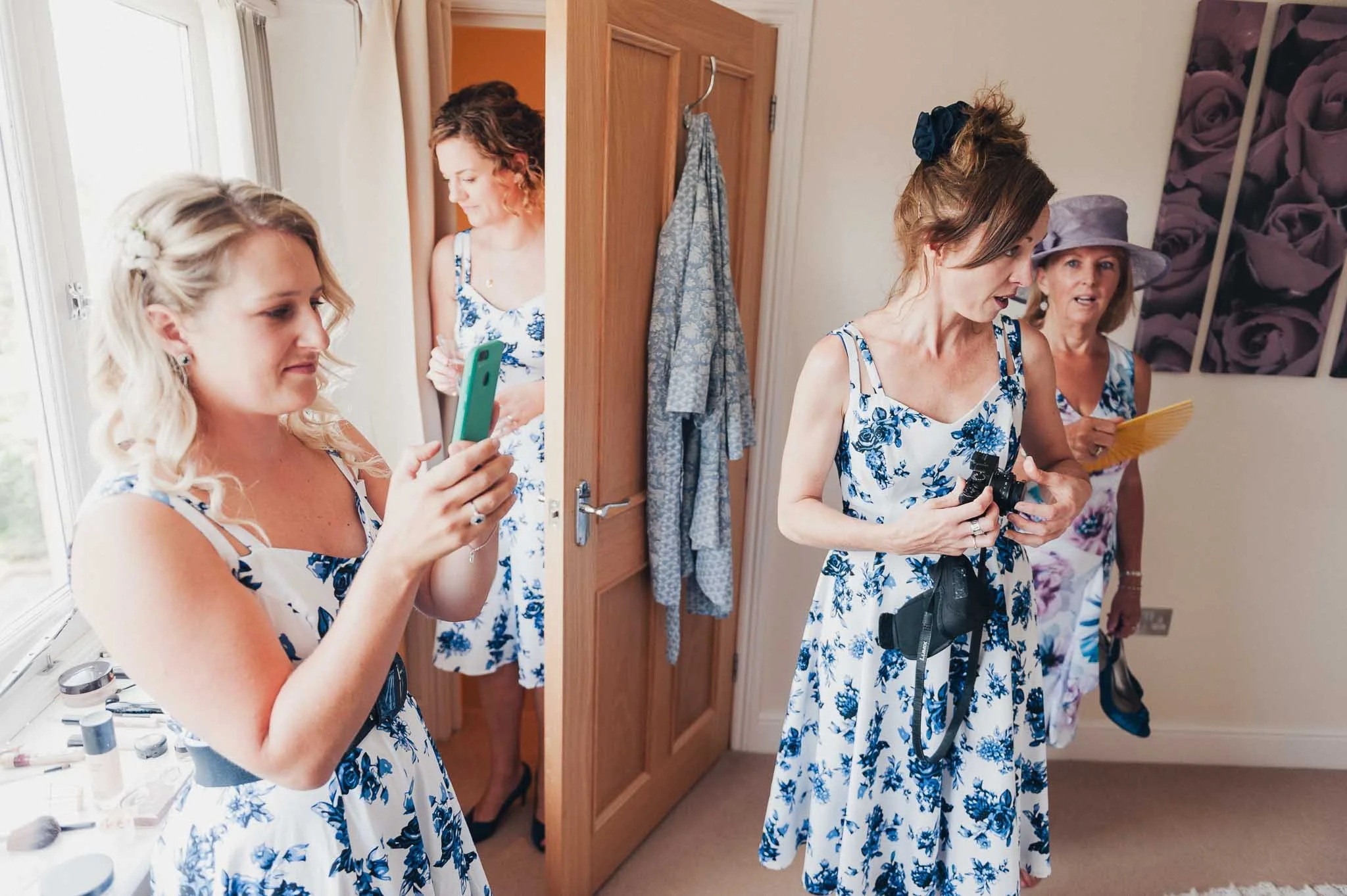 Bridesmaids holding fizz and reading notes or cards during the morning preparations.