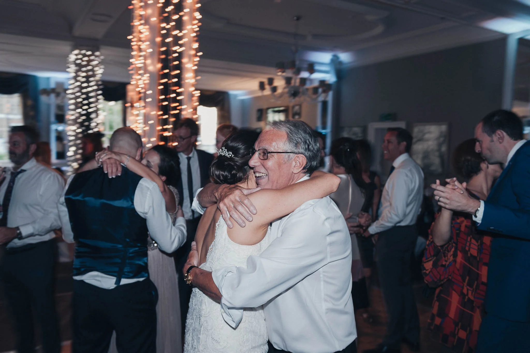 The bride embracing a guest during the evening party celebrations.