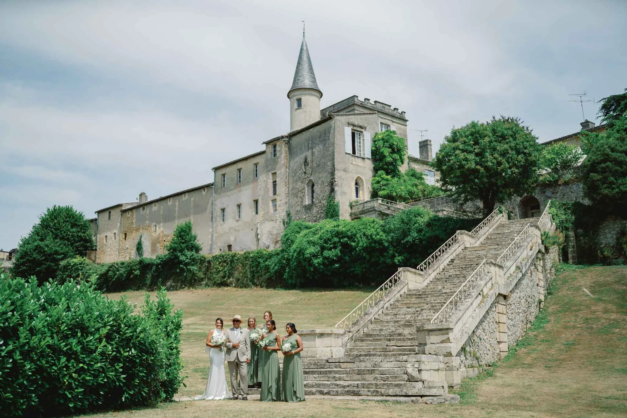 Bridesmaids on the stone steps at Château Lagorce, Bordeaux