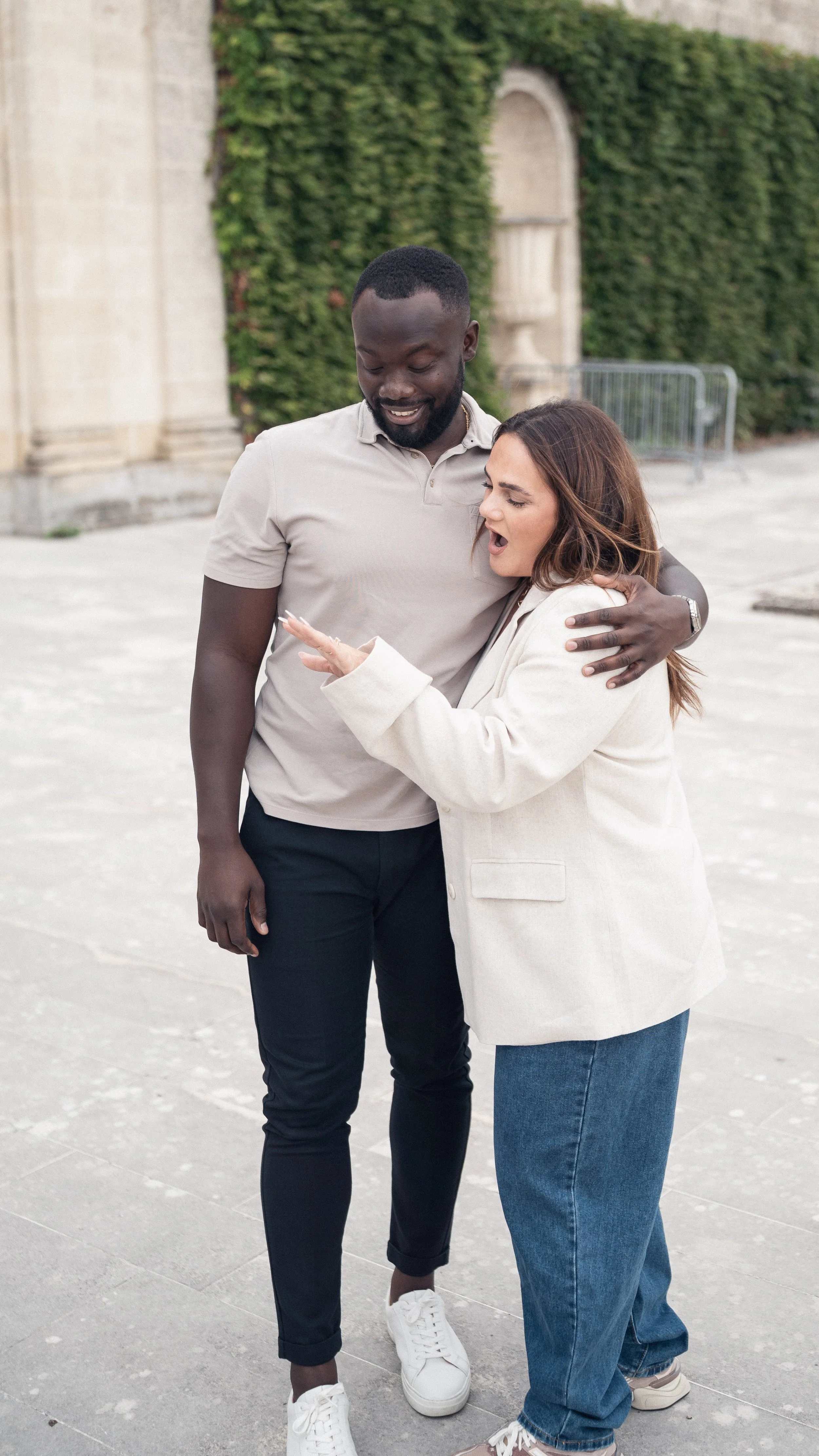 Woman reacting with shock and happiness as she realises she has just been proposed to in Bordeaux.