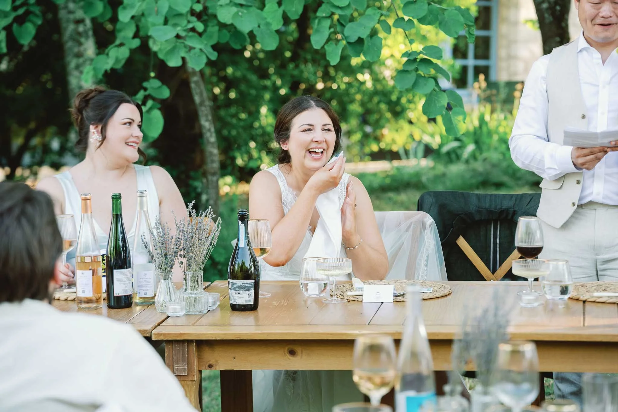Bride laughing during a wedding speech at Château de Panisseau, Dordogne