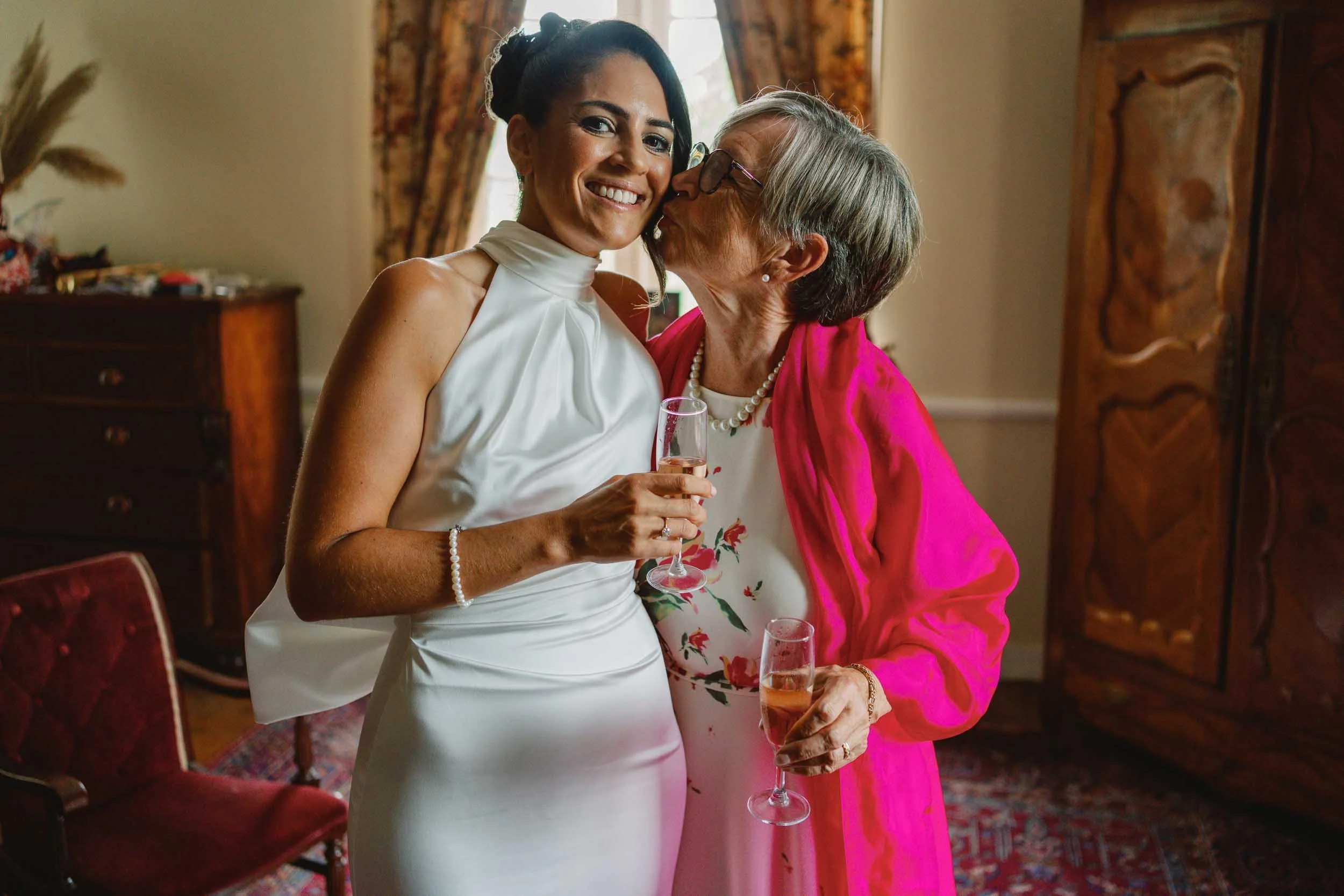 Bride and her mother sharing champagne before the wedding at Château Lagorce, Bordeaux