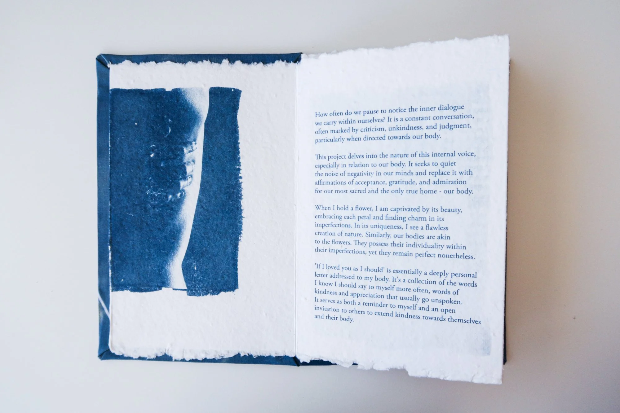 Page from a handmade artist book by Yanina Shevchenko, part of her project If I Loved You As I Should — a body-focused exploration of self-acceptance. Printed on handmade paper using cyanotype, the image combines body forms and natural elements